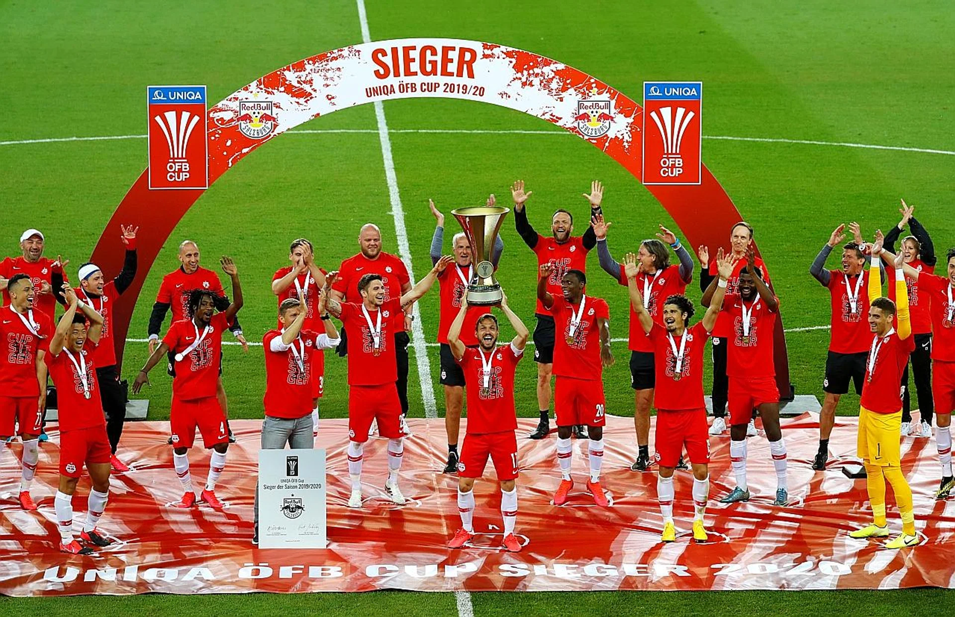 (Above) Red Bull Salzburg's players celebrating their Austrian Cup win while standing on demarcated spots. Players picking up the medals on their own. Fans catching the action at a drive-in cinema. 