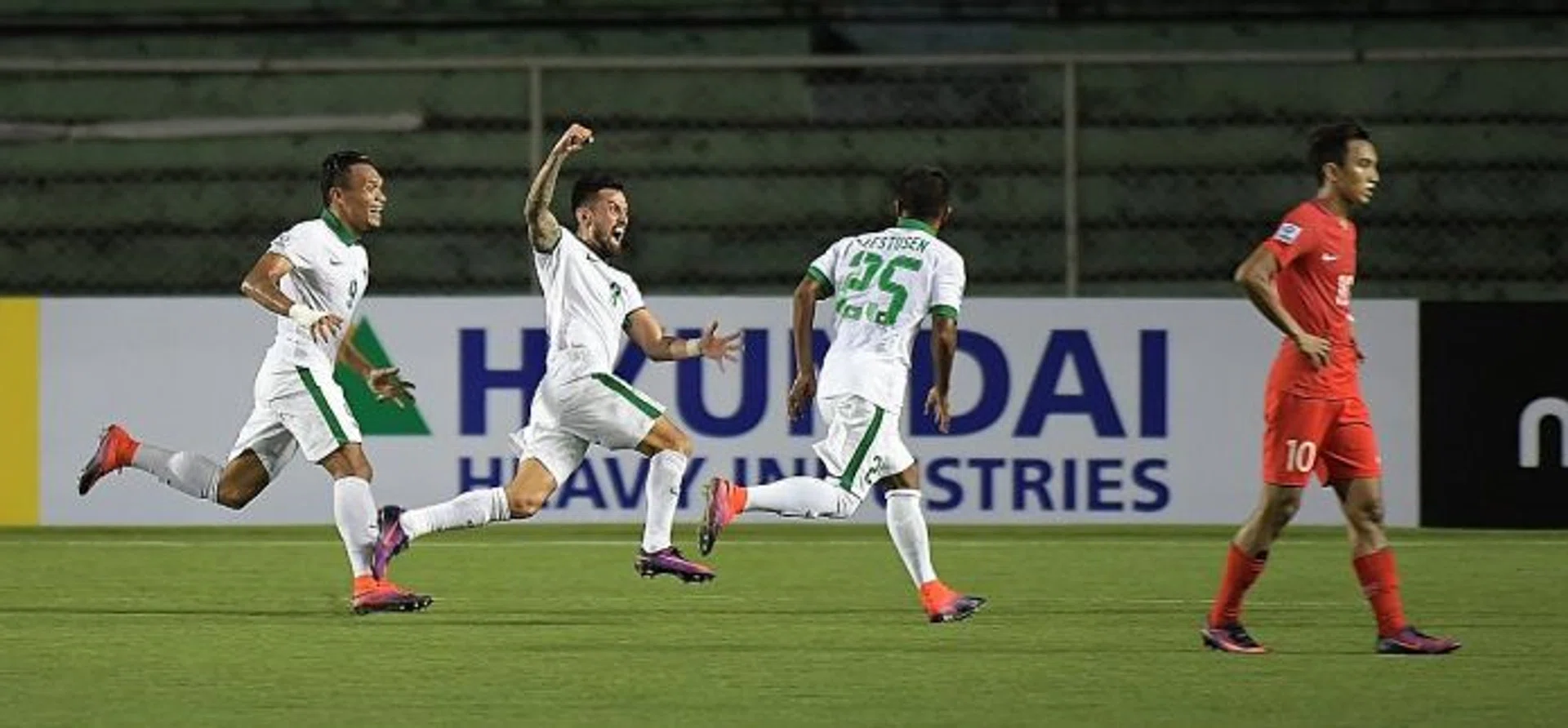 JOY AND DESPAIR: Indonesia's Stefano Lilipaly (second from left) screaming in delight after scoring the winning goal, as Singapore forward Faris Ramli (right) walked away.