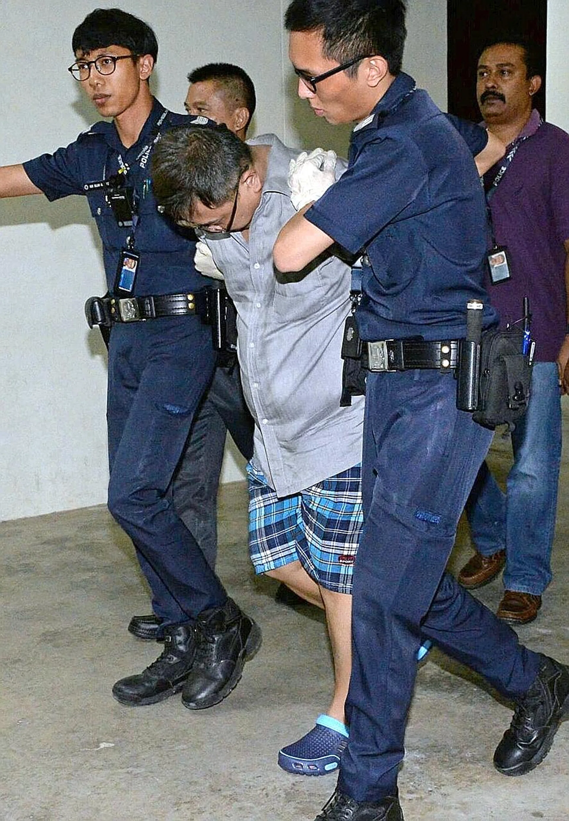 Teo Ghim Heng in police custody.