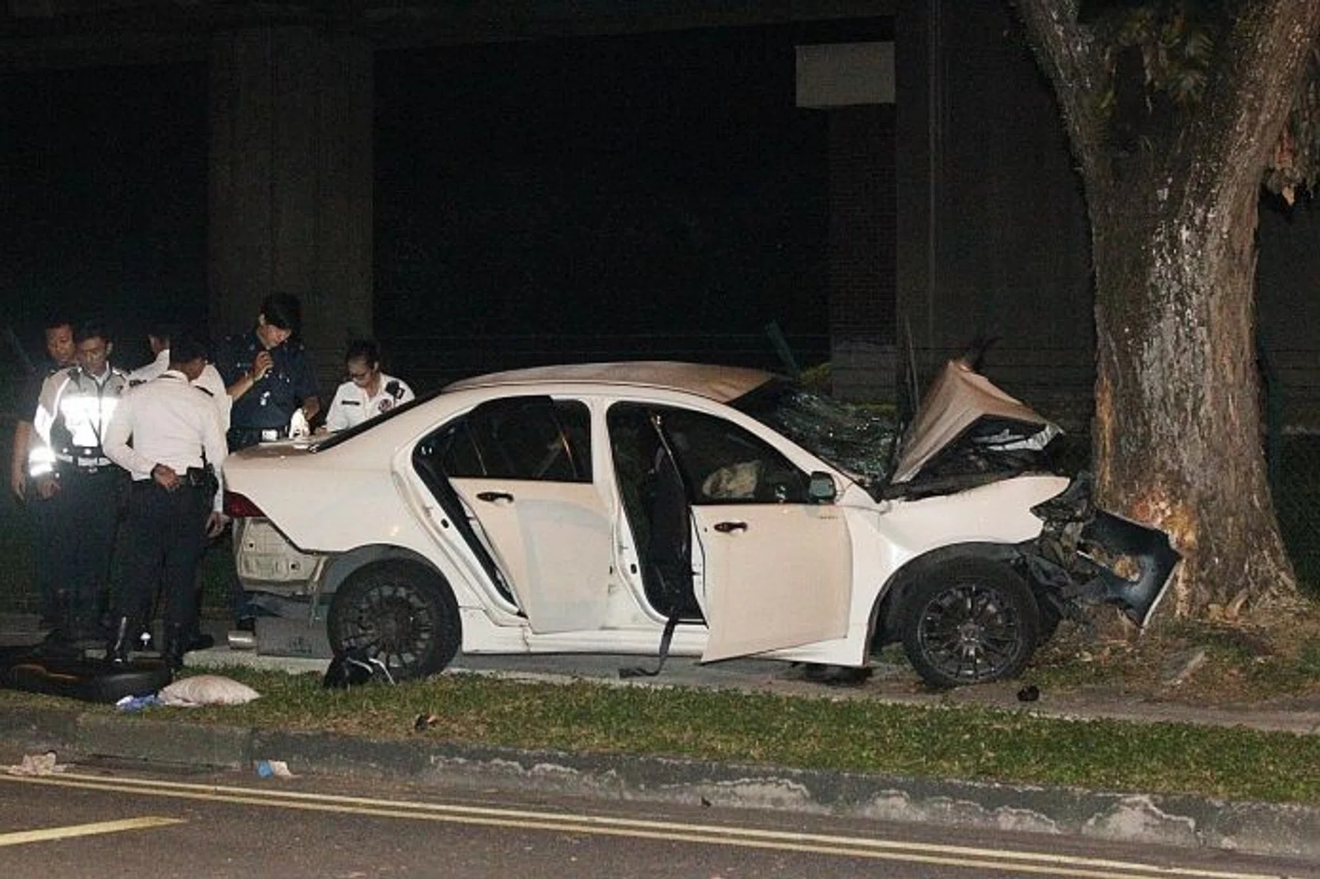 HORRIFYING: (Above) The car crashed into a tree at about 1am yesterday at Lentor Avenue. 