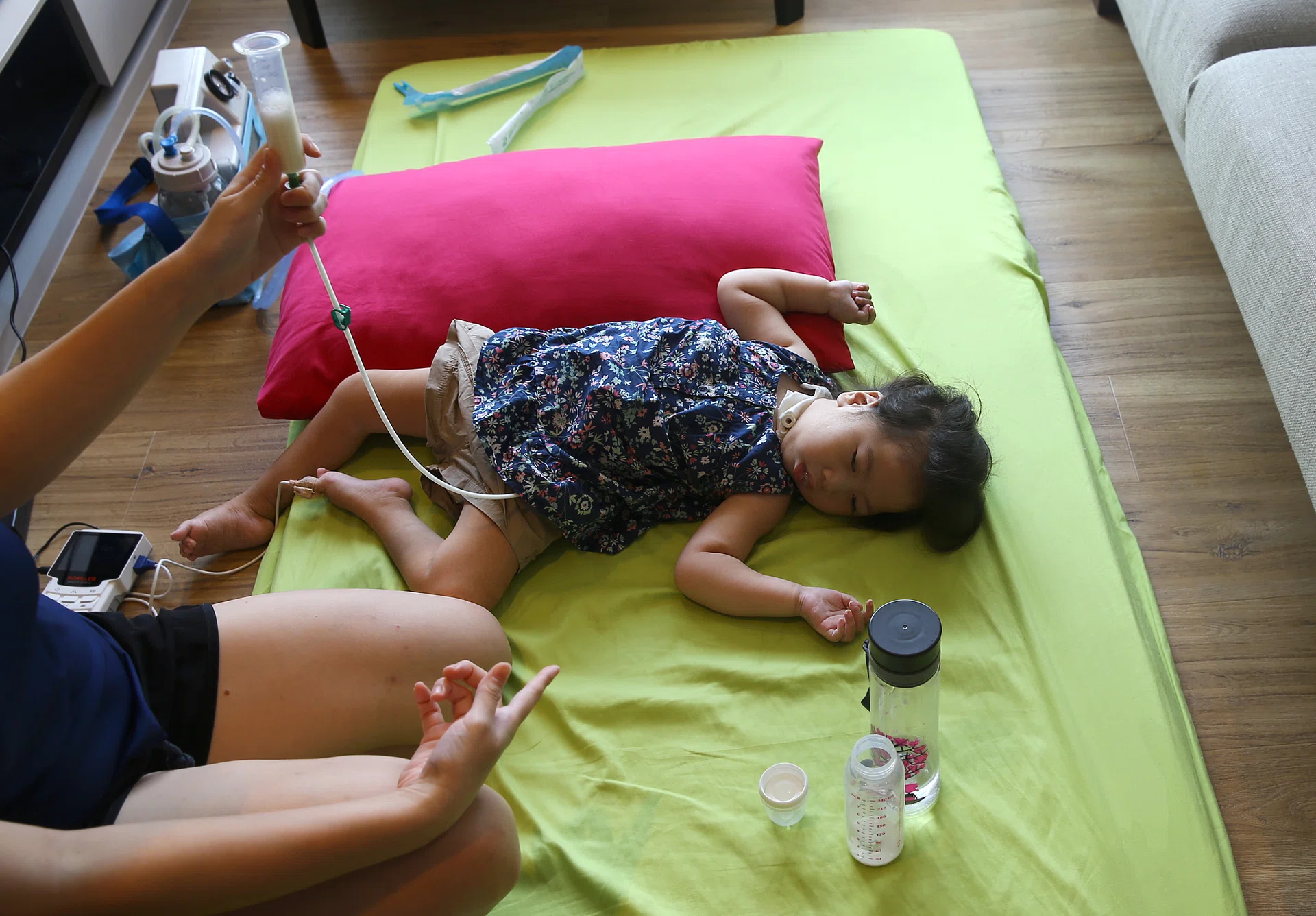 WEAK: Madam Jasmine Lim feeding Sarah through a tube in her stomach as she is unable to swallow.