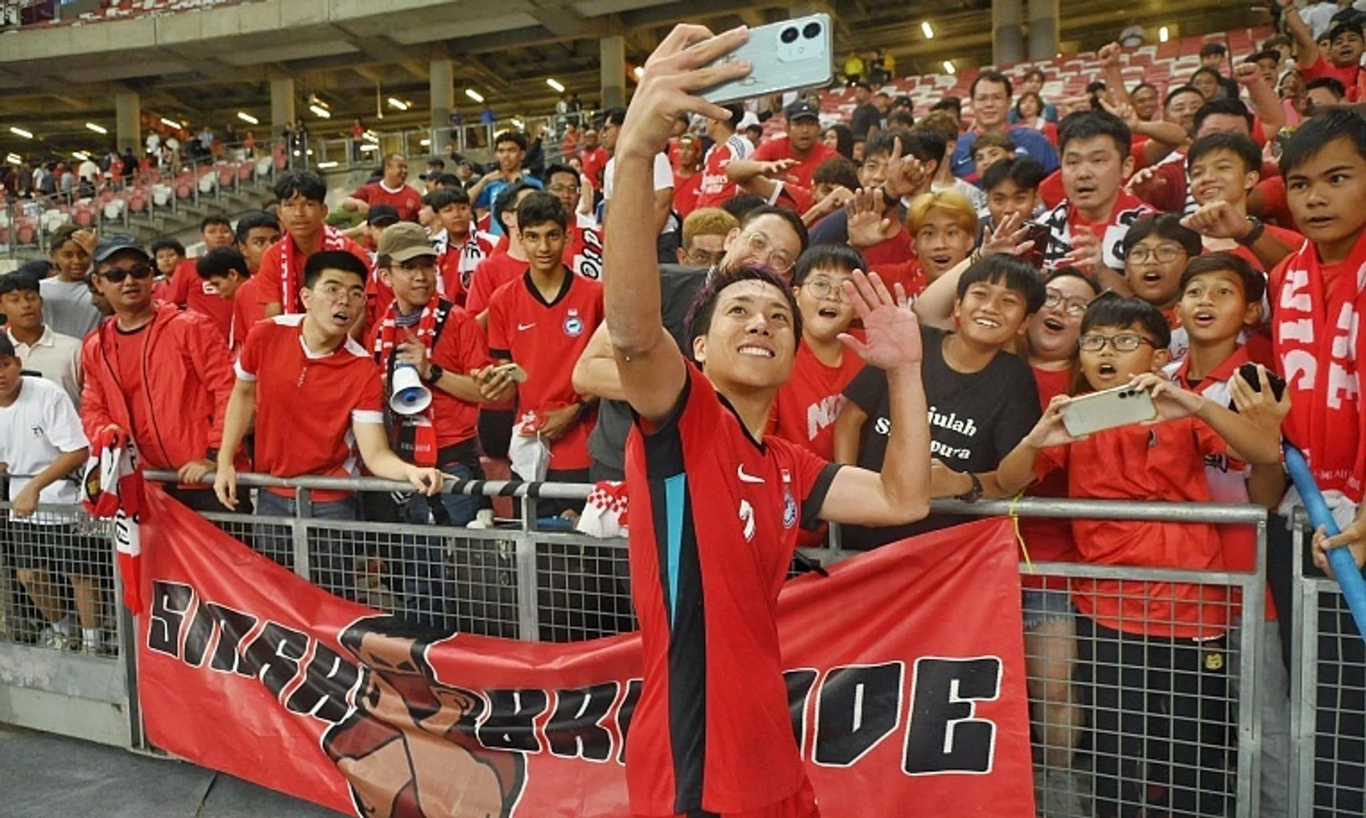 Singapore midfielder Kyoga Nakamura taking a wefie with  Lions supporters after their recent friendly 3-2 win over Myanmar on Nov 14.