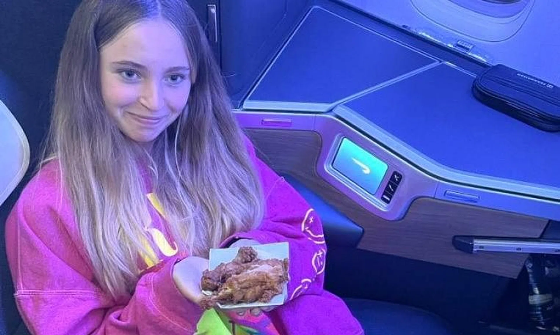 A British Airways passenger shows the fried chicken she got for her only meal on a 12-hour flight from the Bahamas.