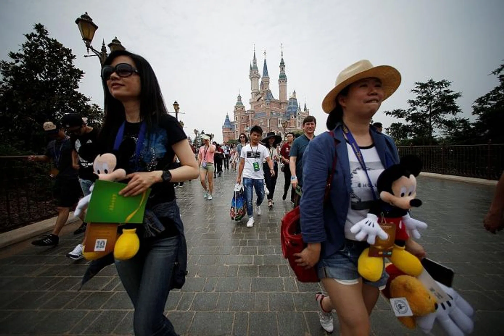 FAIRY TALE BEGINNINGS: Visitors explore the theme park with a view of the 60m-high Enchanted Storybook Castle in the background. 