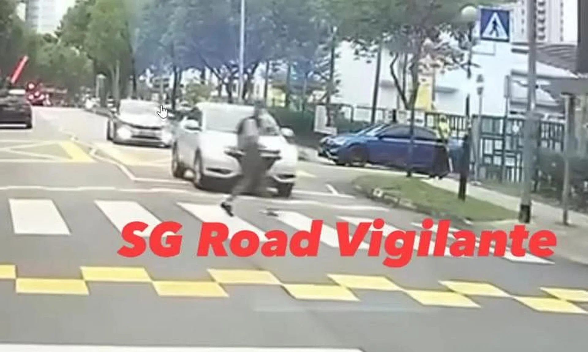 The girl is seen running across a zebra crossing after a road traffic warden waves her through.  