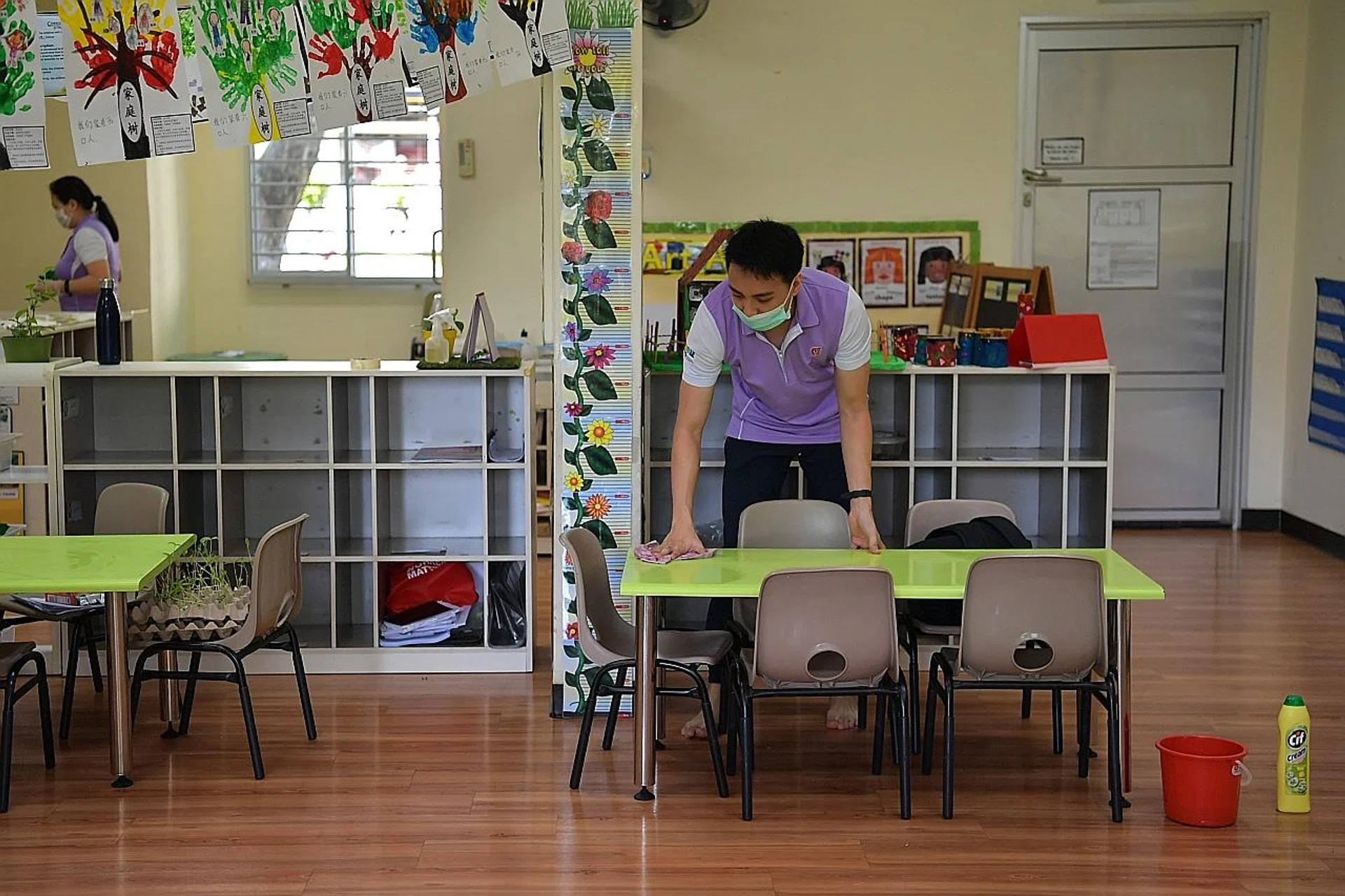 An employee of PCF Sparkletots pre-school at Block 307 Clementi Avenue 4 cleaning the K1 classroom. All 360 PCF centres will be closed till Sunday, except the Fengshan centre, which will be shut till April 7. 