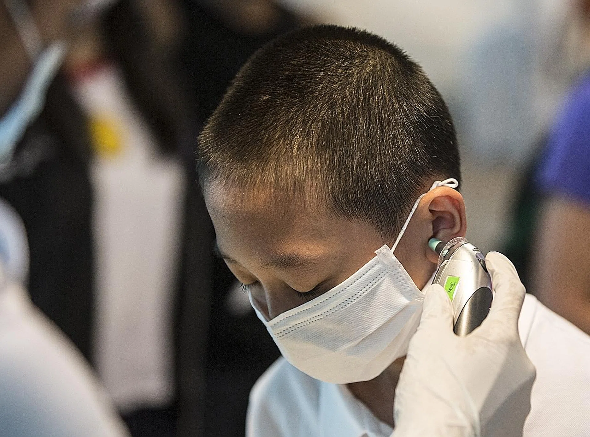 A boy having his temperature checked at the Kuala Lumpur International Airport yesterday. 