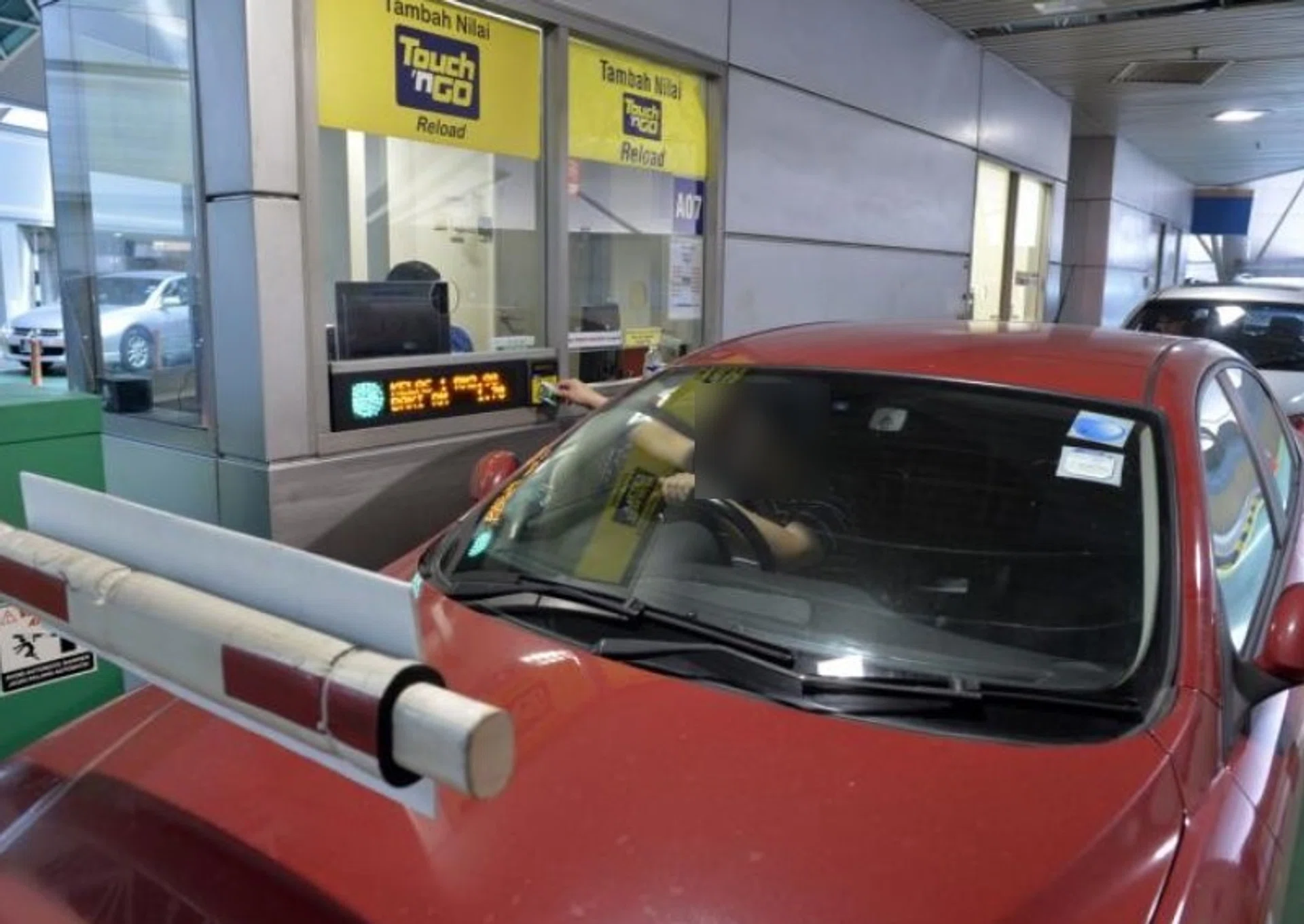 A motorist clearing formalities at a Malaysian checkpoint.