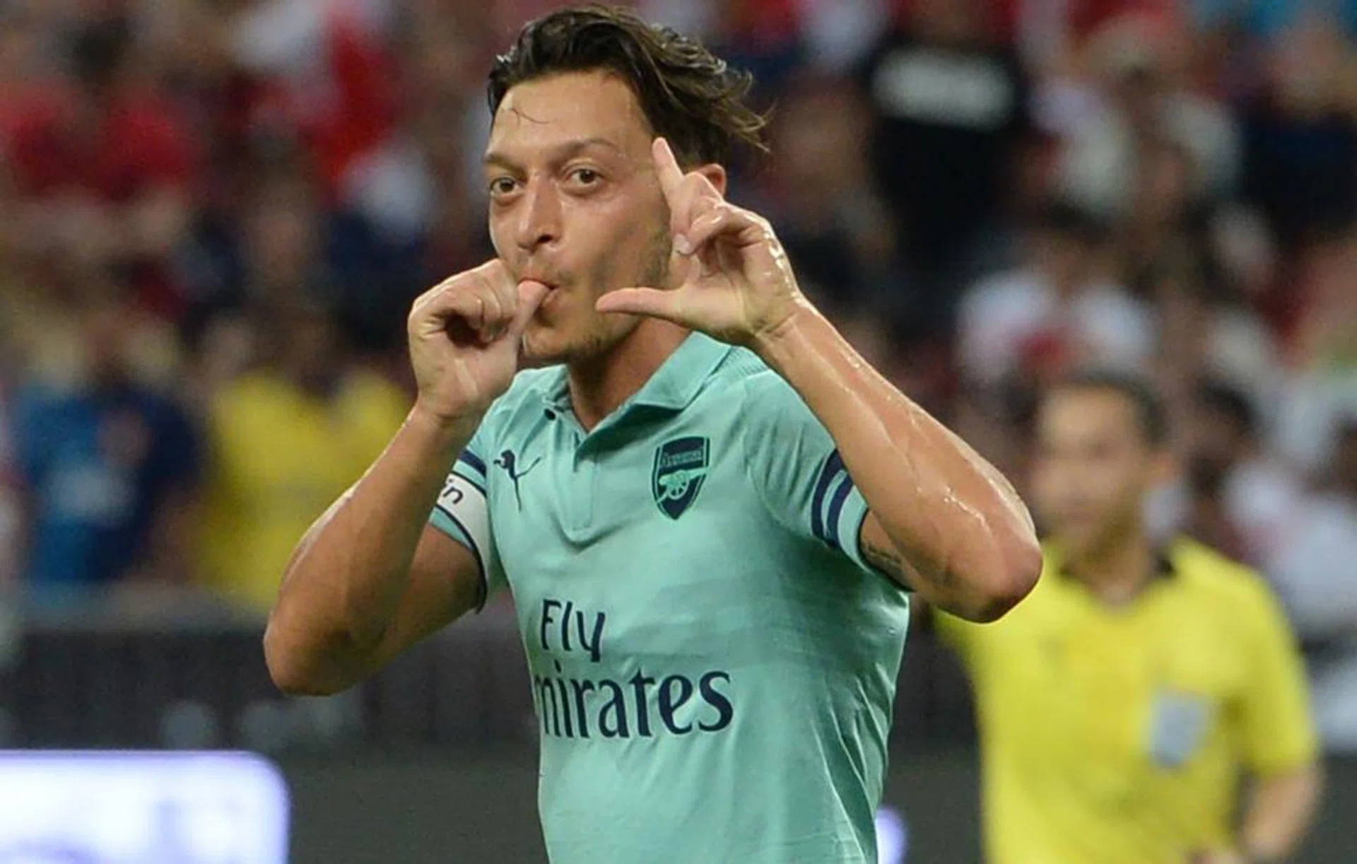 Mesut Oezil celebrates after scoring the opener in their 5-1 win over Paris Saint-Germain.