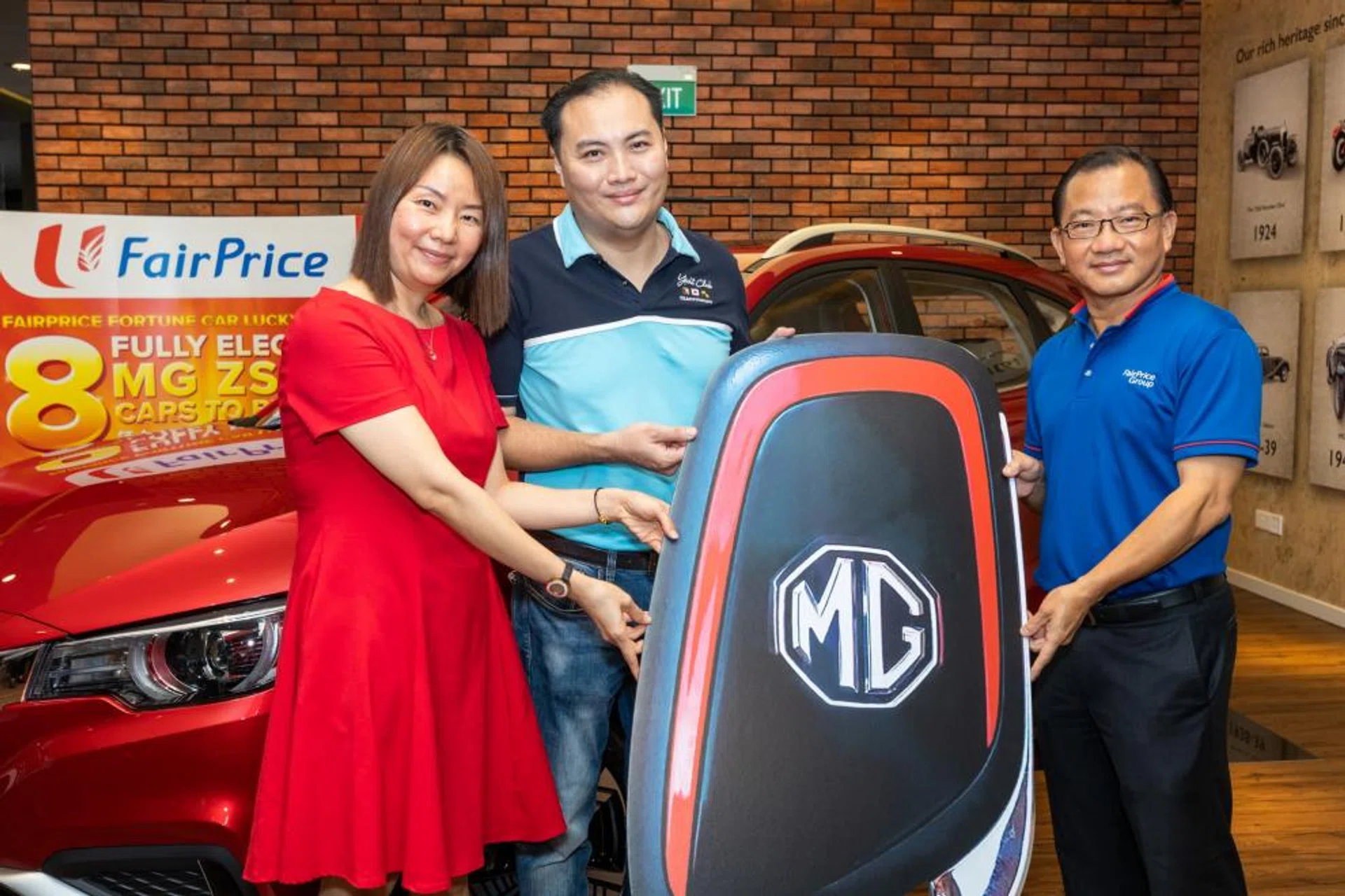 Ms Choo Gaik Ting and husband with Mr Seah Kian Peng (right), group chief executive of FairPrice Group.