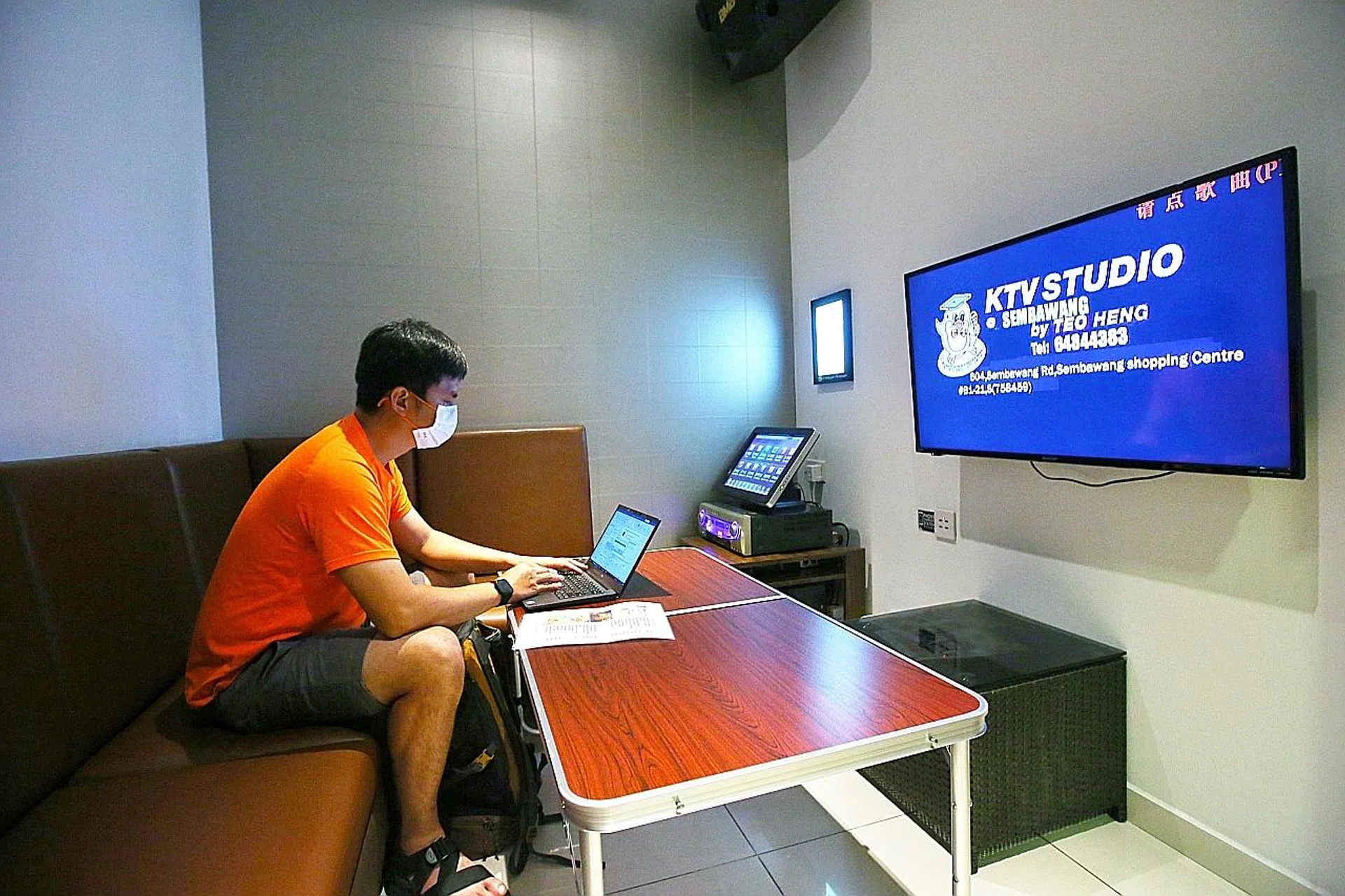 A customer at Teo Heng's Causeway Point outlet on his laptop after the place reopened for customers to "work, dine and chill" on March 19. Sing My Song Family Karaoke took a similar route for its Paya Lebar Square outlet, where customers book rooms to play card games. 