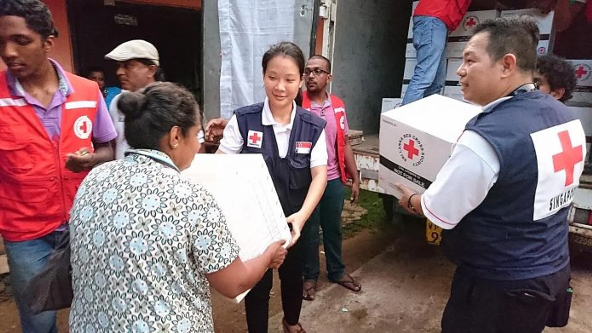 RESCUE TEAM: Miss Charis Chan and Mr Peter Tung of Singapore Red Cross, helping the victims of the recent flood in Sri Lanka.