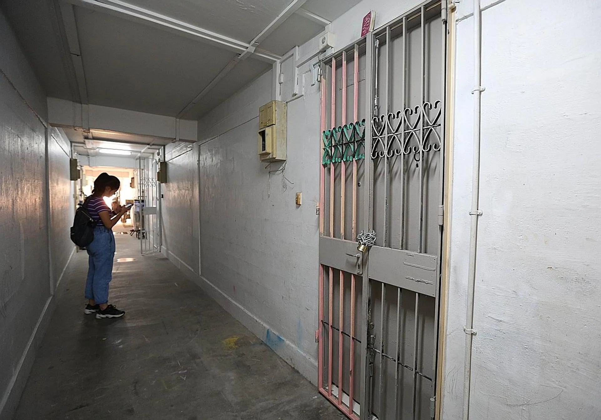 The unit's gate had been padlocked with a thick chain and a red book with religious text was resting on the top frame of the gate. 