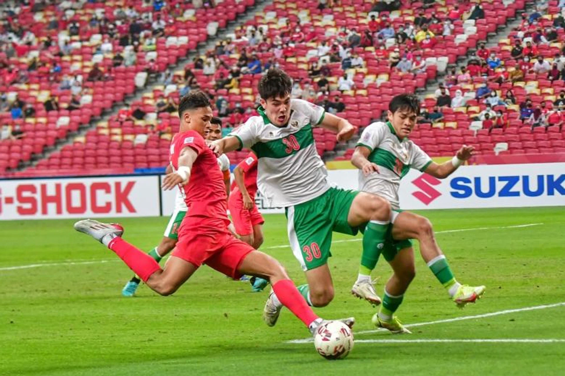 Singapore's Ikhsan Fandi (in red) in action during the AFF Suzuki Cup 2020 semi-final first leg match against Indonesia on Dec 22, 2021.