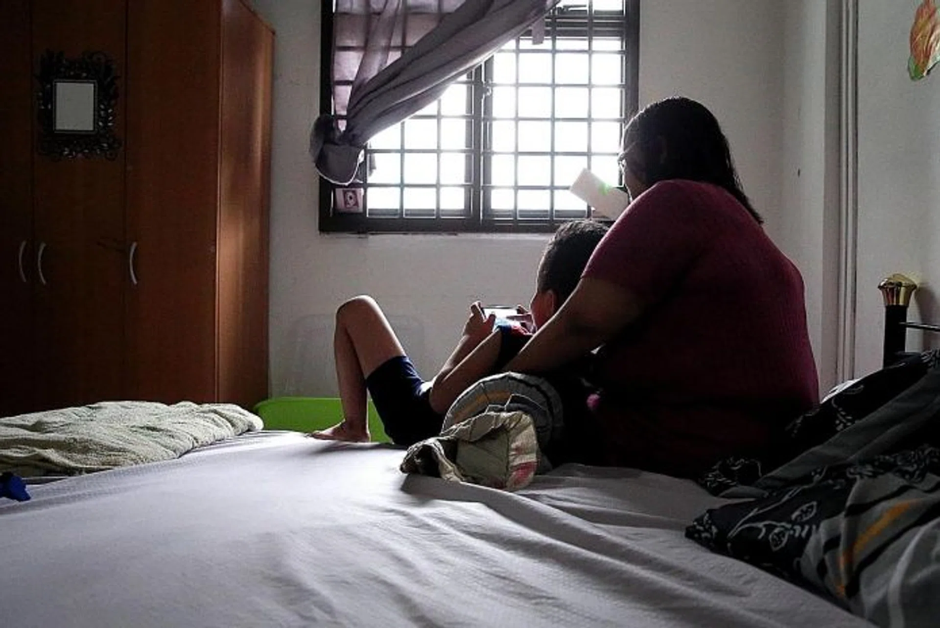STILL HAPPY: Madam Nora with her six-year-old son, who has mild autism and a low IQ. She also has two daughters.