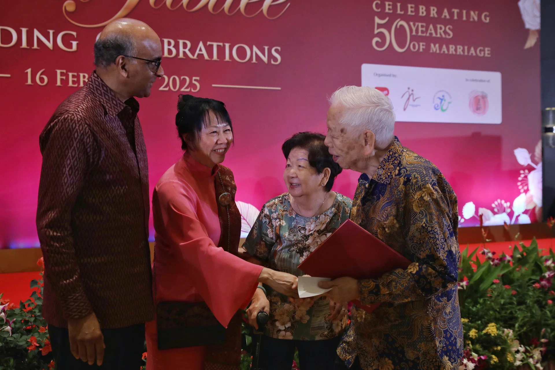 President Tharman Shanmugaratnam and his spouse Jane Ittogi presenting a commemorative marriage certificate to Mr Peter Chua and his wife Molly Foong at the Golden Jubilee Wedding Celebrations on Feb 16.
