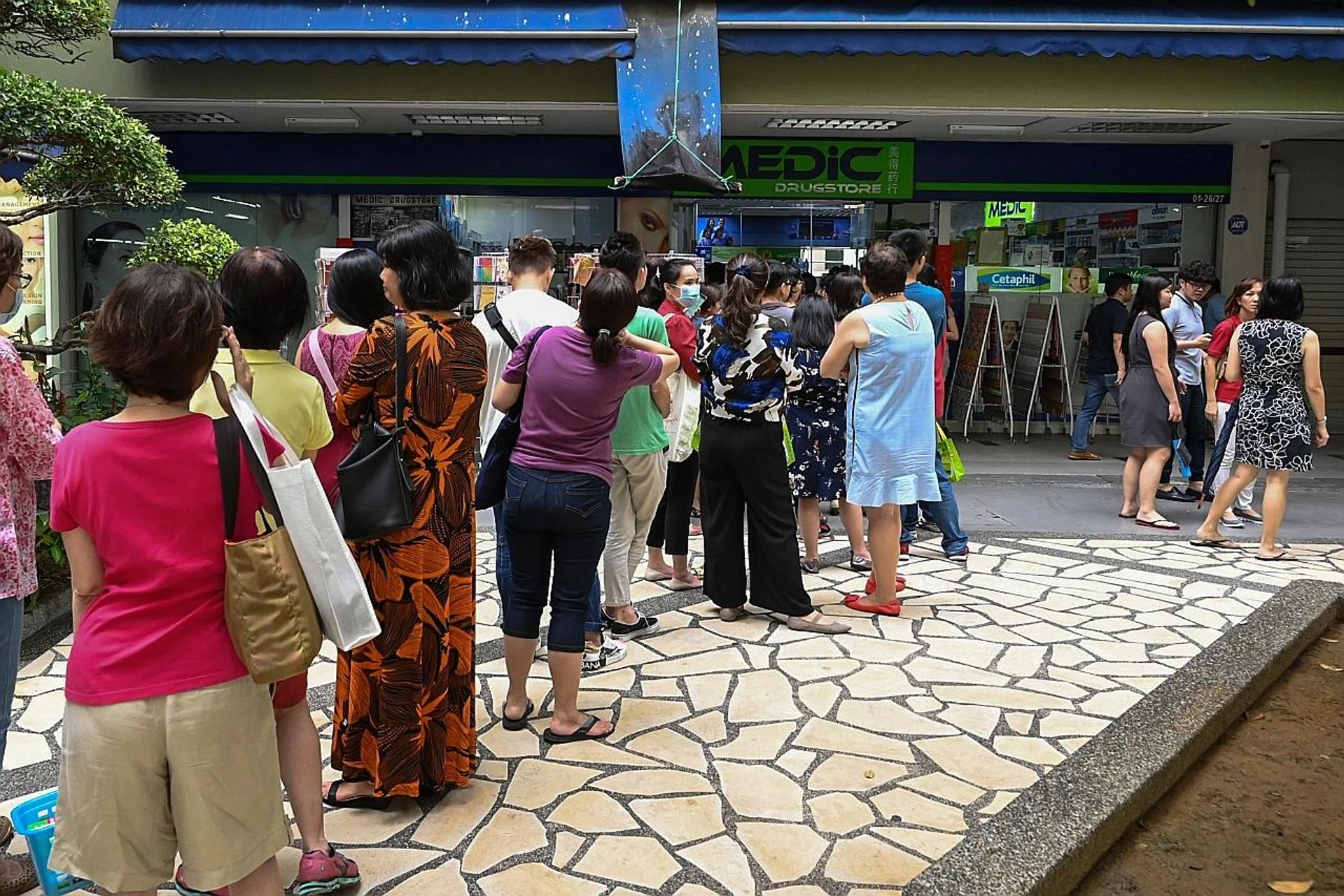 People queueing outside a pharmacy yesterday. 
