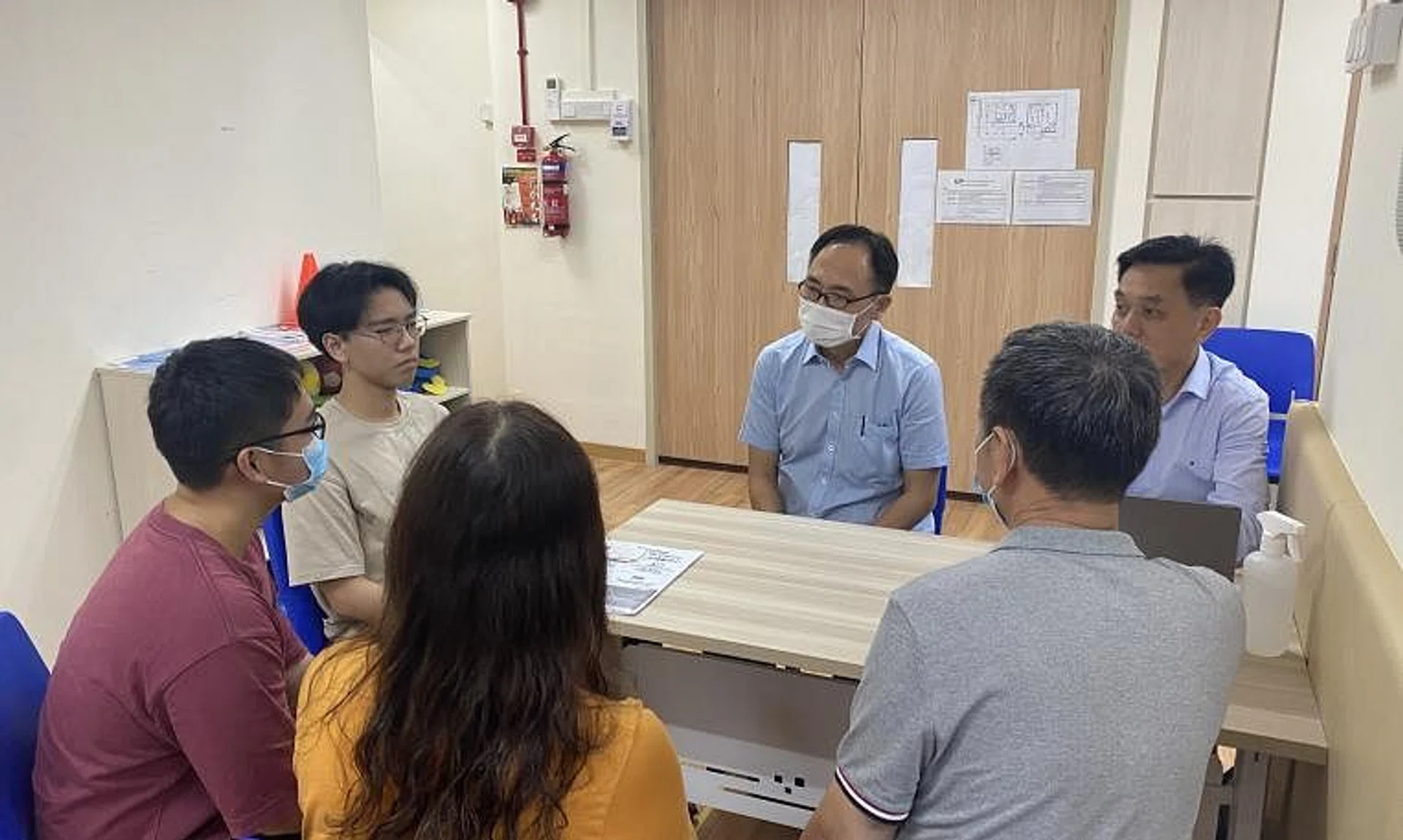 Bukit Panjang MP Liang Eng Hwa (centre) speaking to residents at his Meet-the-People Session on July 31, 2023. 