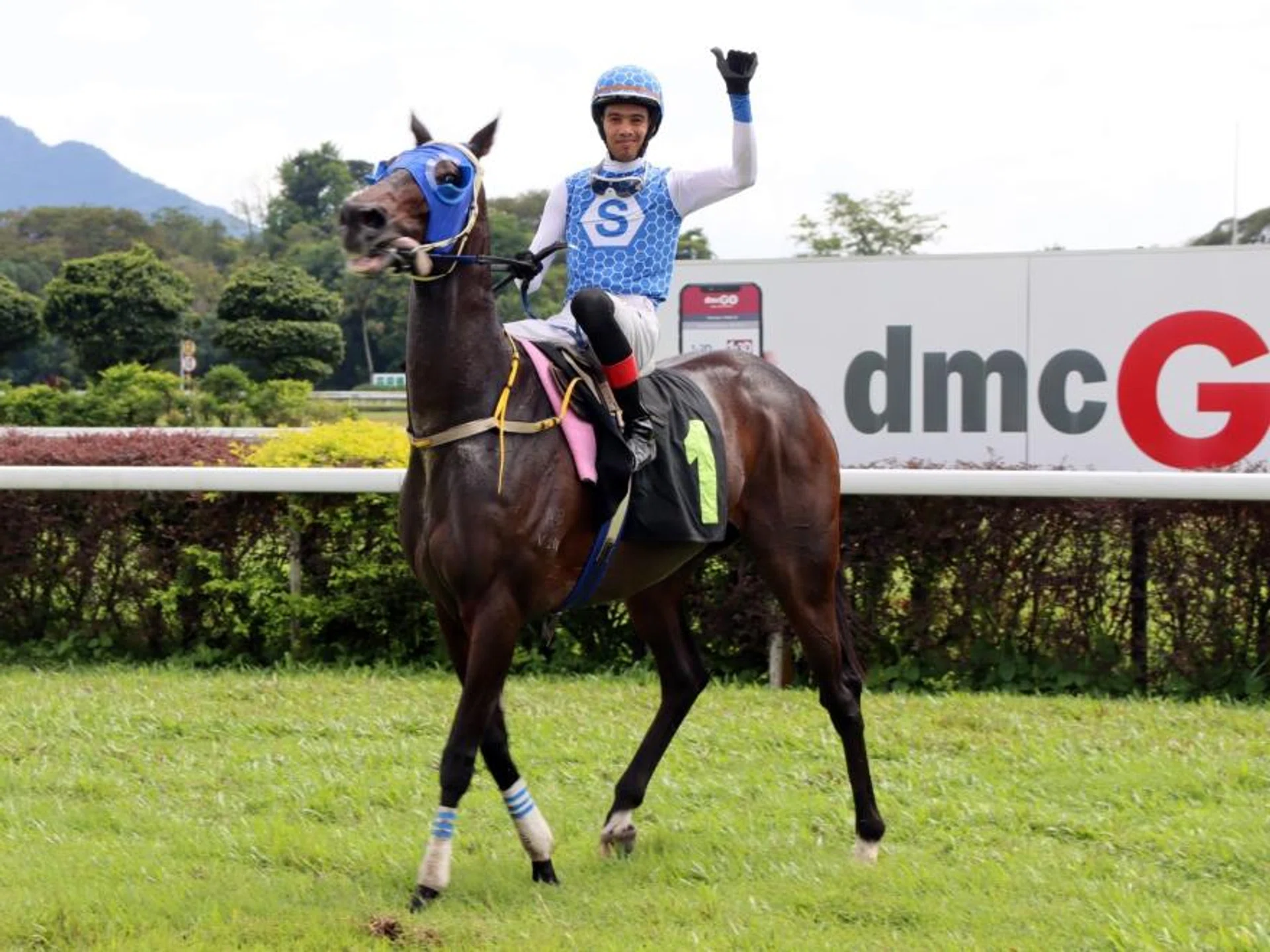 Apprentice jockey Syafifie Zailuddin all smiles as he brings Ahtims Klis back to the winner's enclosure in Race 2 at Ipoh on Jan 5.
