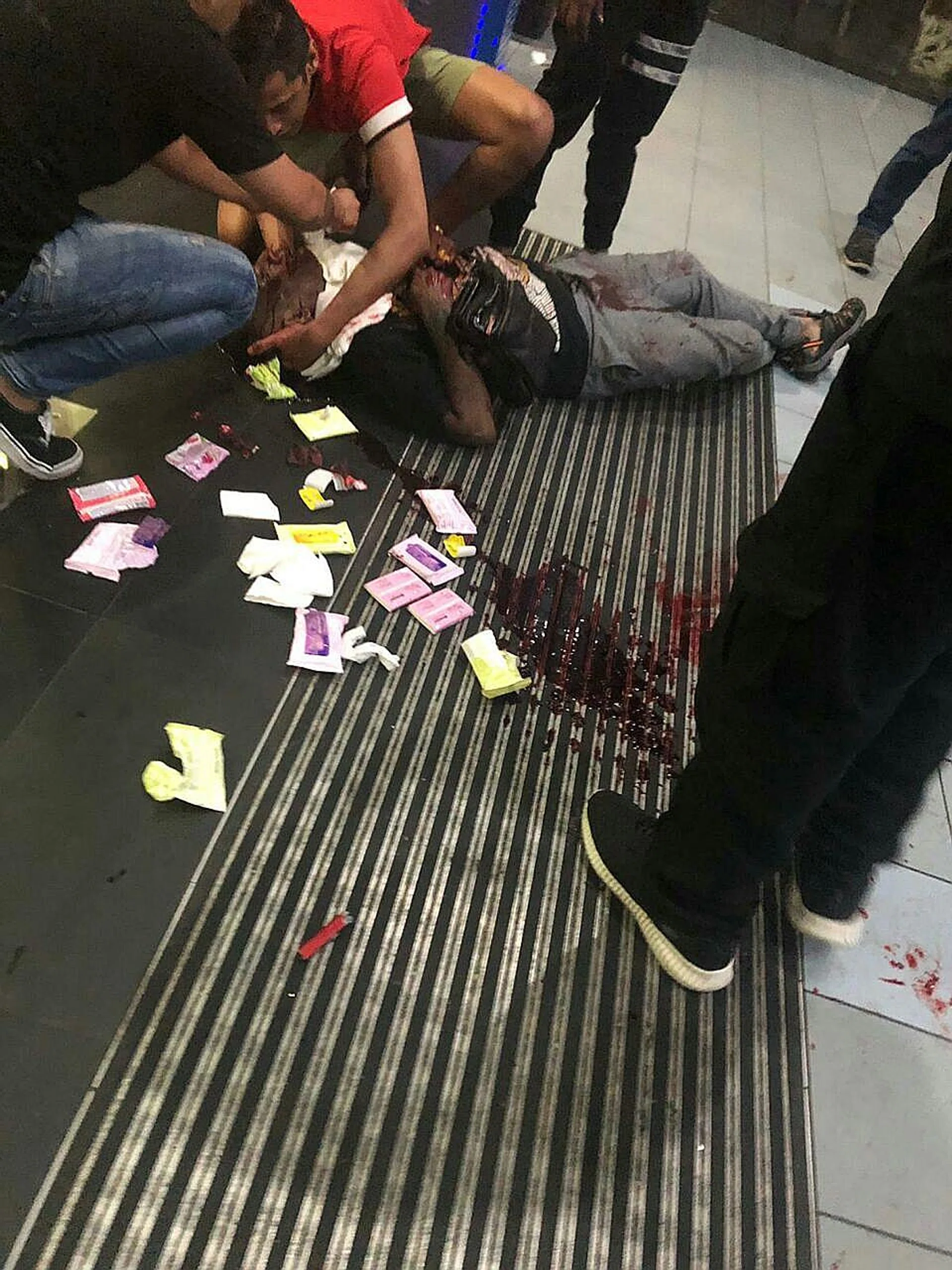 Several people tried to stem the victim's heavy bleeding with packets of tissue paper. 
