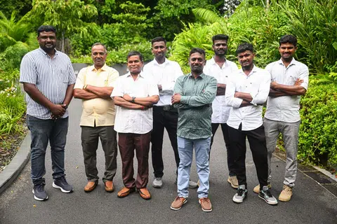Mr Pitchai Udaiyappan Subbiah (centre, in green), a construction site foreman who rescued a driver of a car that fell into the Tanjong Katong sinkhole, with his colleagues at the Istana open house on Aug 3.