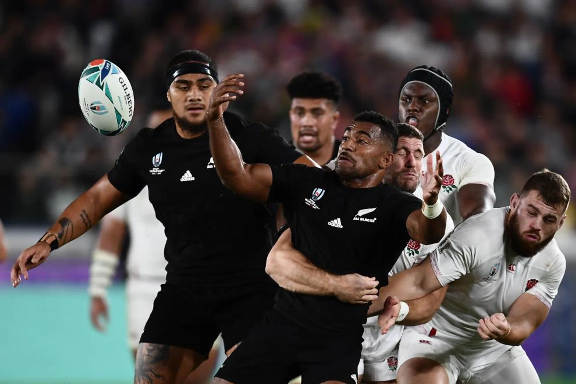 New Zealand's wing Sevu Reece (centre) trying to break through the England defence.