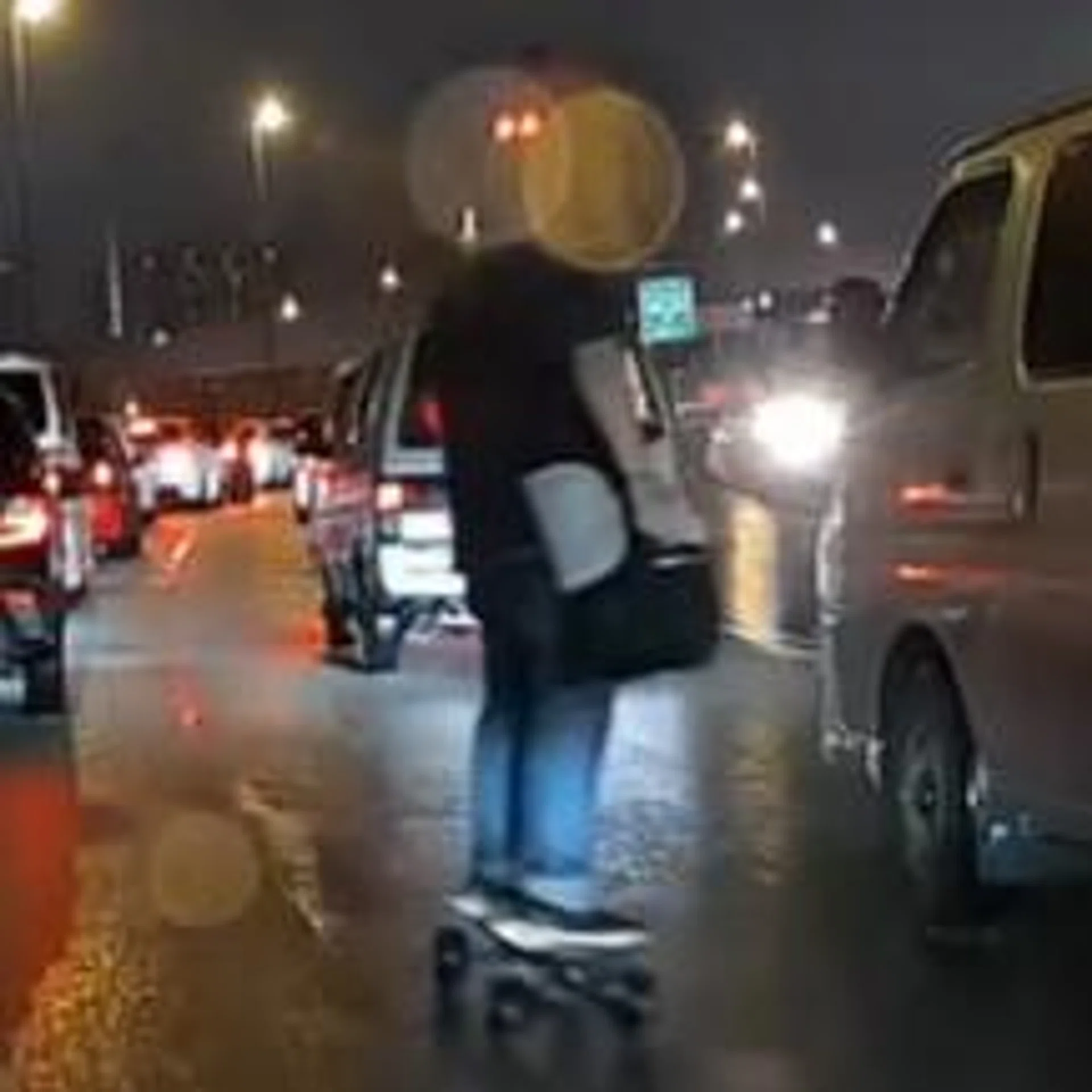 The man was seen rolling through the cars while it was raining heavily.