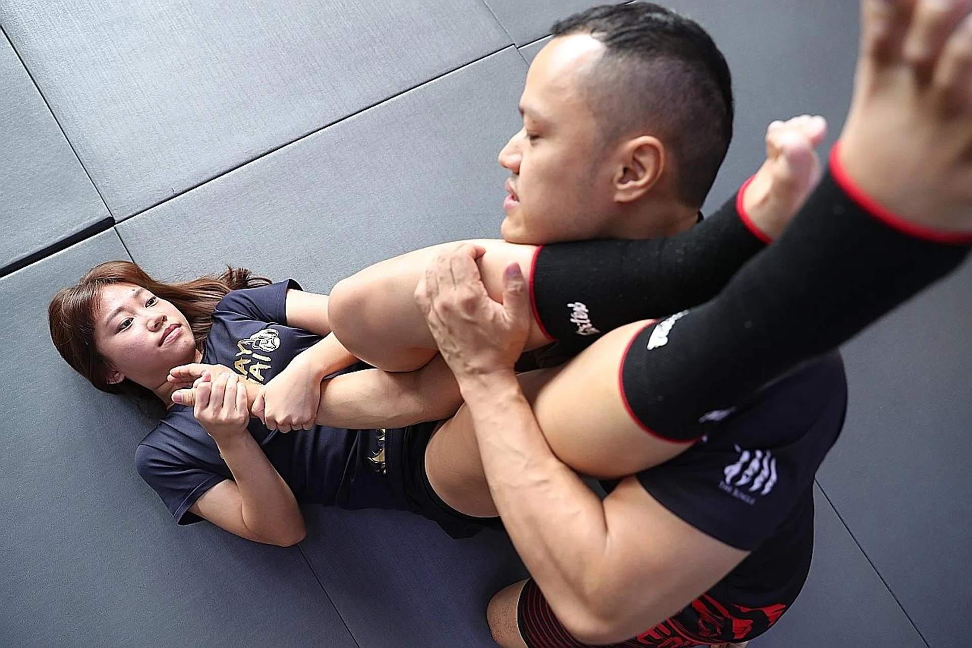 (Above) Ms Lili Pan, who owns a muay thai studio, demonstrating self-defence moves with Mr Alexandre Leung, a gym owner.