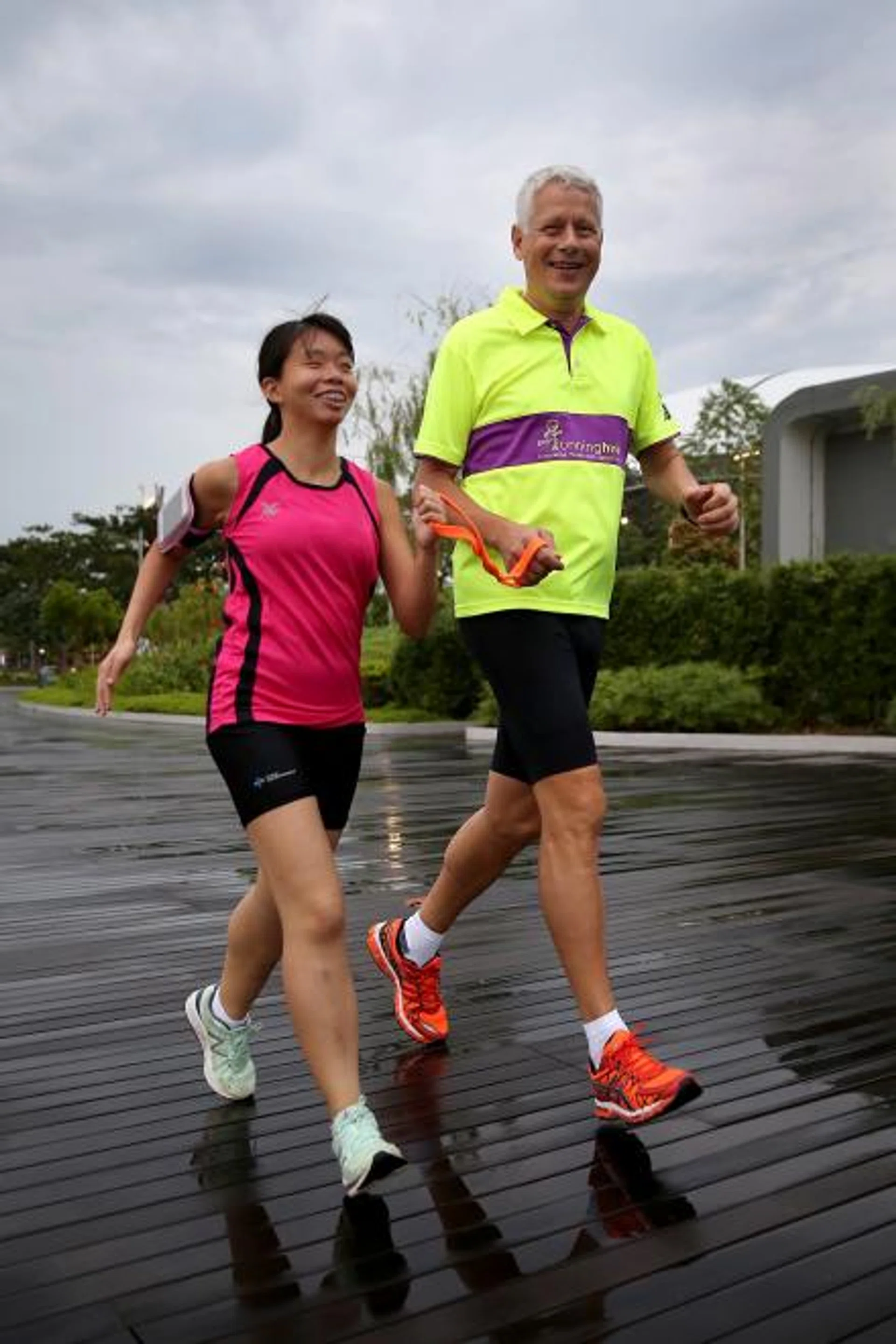 Mr Jakob Bader (right) says volunteering as a running guide has become a part of his life.