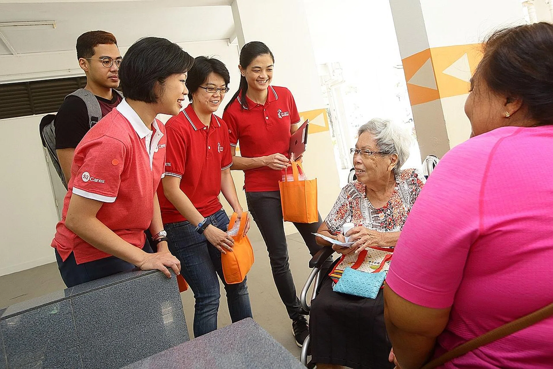 (From left) MCCY and MCI Senior Minister of State Sim Ann and national bowlers Muhd Danial (in black), Cherie Tan and Daphne Tan giving out masks and hand sanitisers to residents yesterday. 