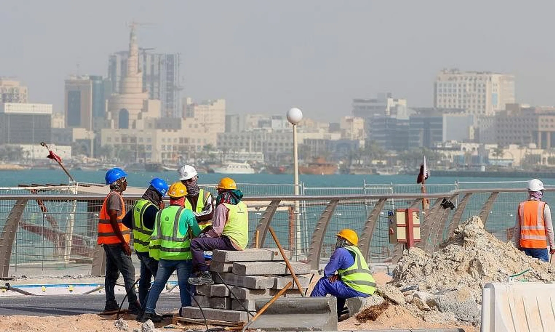 Workers seen fixing a sidewalk in May in the capital Doha, ahead of the Qatar 2022 Fifa World Cup.