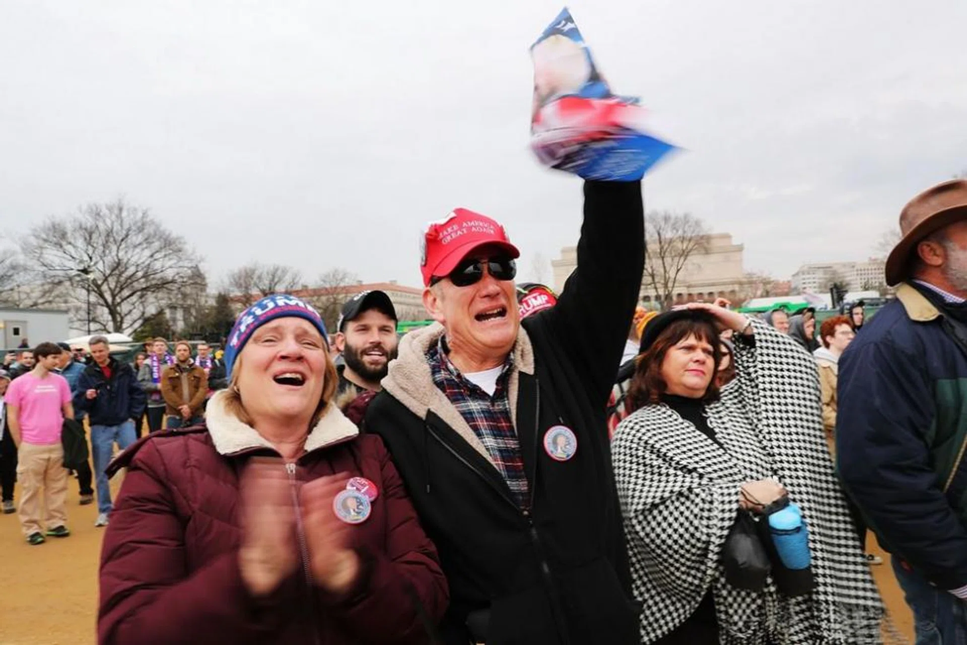 US President Donald Trump supporters react on the National Mall to the inauguration of US President Donald Trump on January 20, 2017 in Washington, DC.