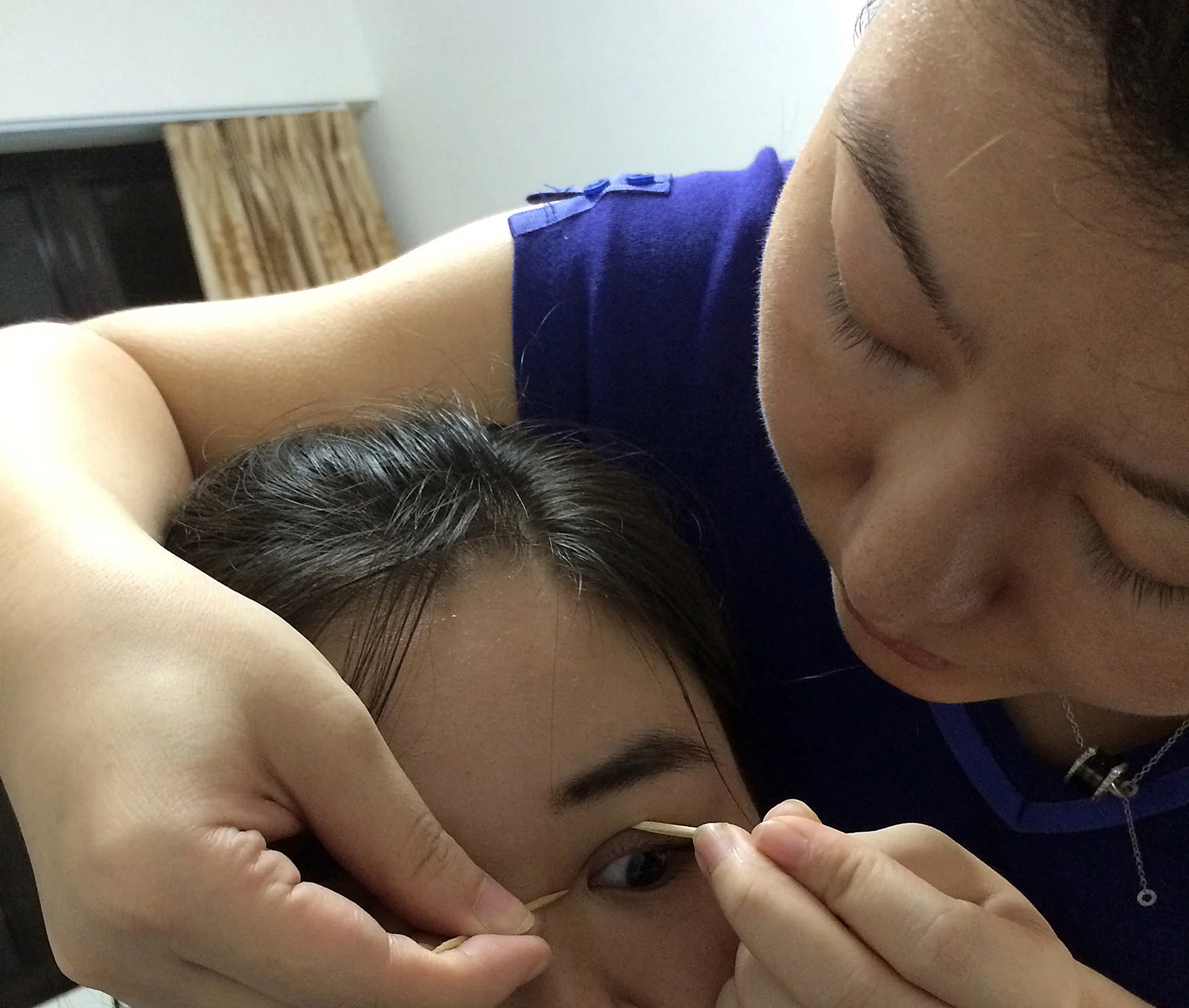 SALES PITCH: The woman using toothpicks to show how surgery to get rid of skin from the inner corners of the eyes would enhance a client’s looks.