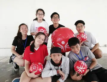Youth with and without disabilities mingle with one another at camp
