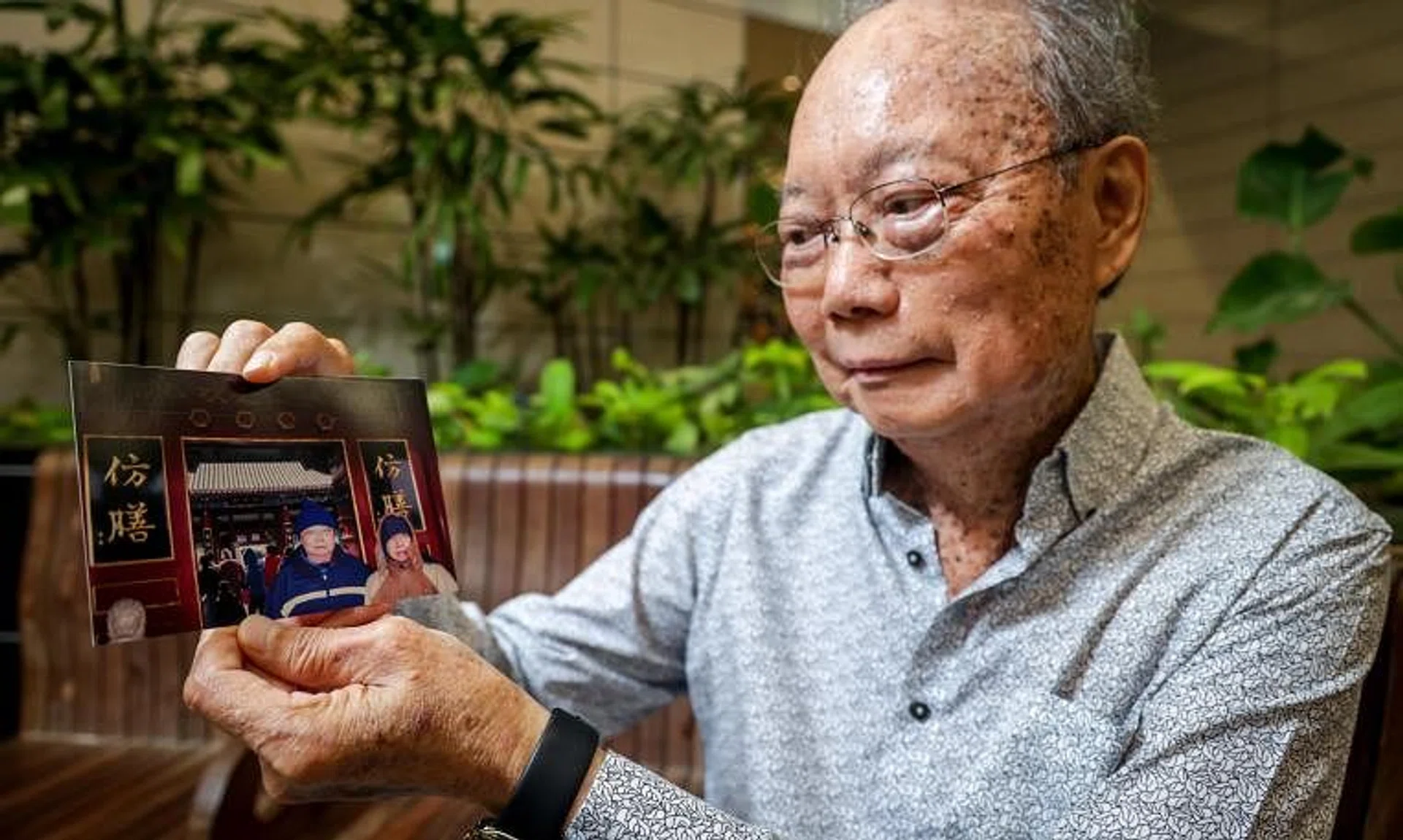 Mr Kong Fook Seng with a photo of himself and his late father Kong Wing Hing during a trip to China.