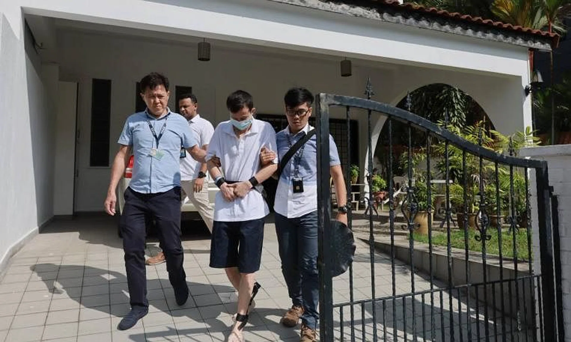 Chinese national Wei Qingyou being taken back to the crime scene, comprising landed estates beside Pasir Ris Park, in September 2023.