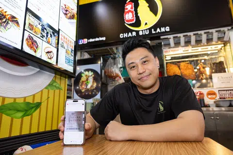 Char Siu Lang founder Ivan Leong showing his winning Toto ticket.