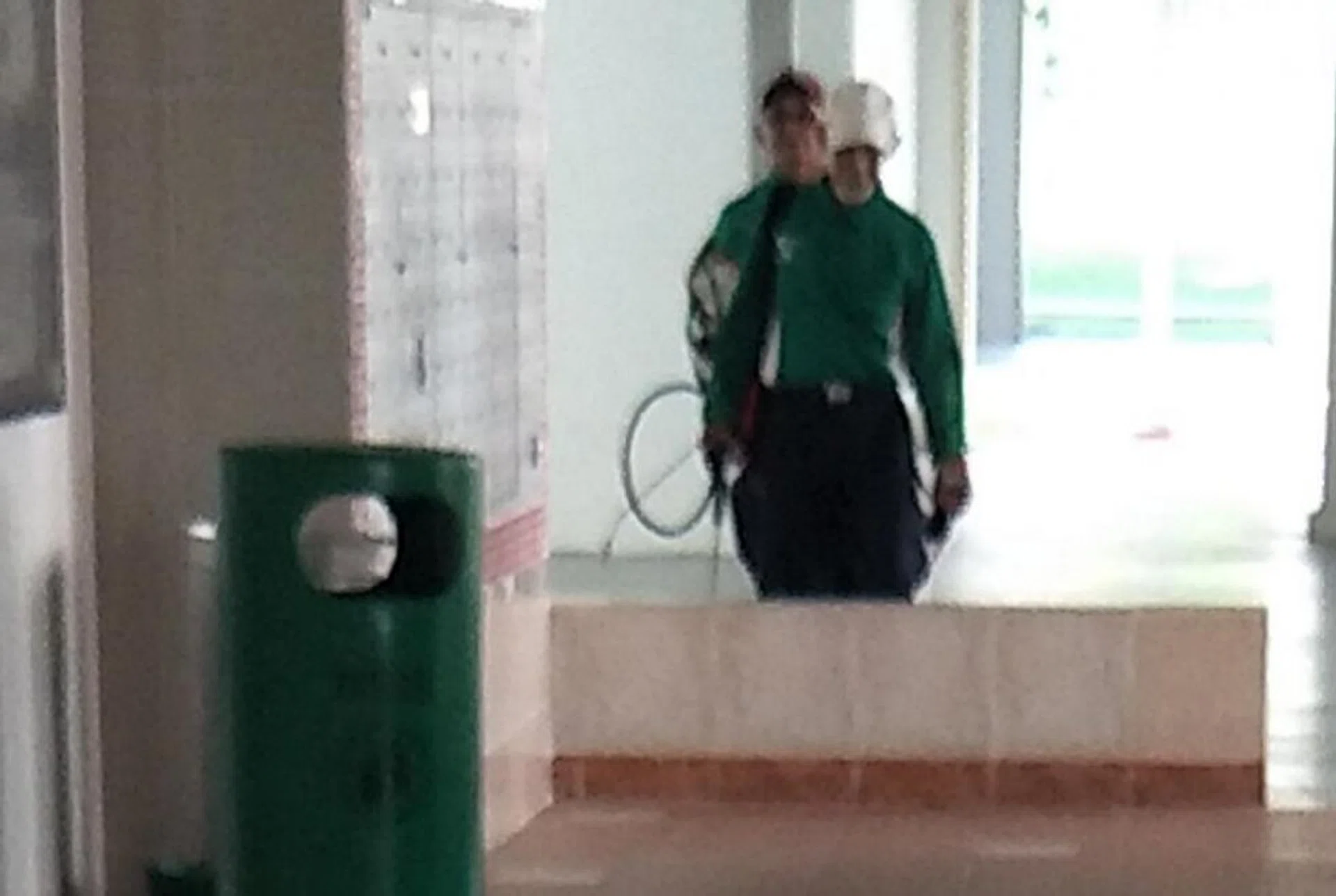 Officers checking drains for signs of mosquito breeding in Jurong West Street 91. 