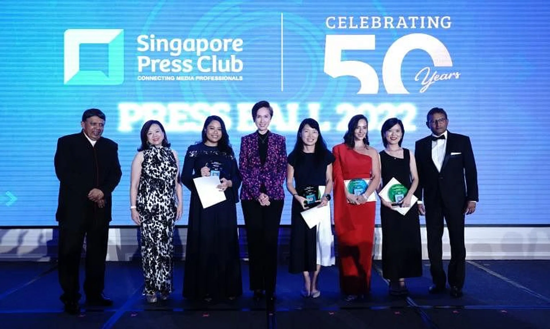 Communications and Information Minister Josephine Teo (fourth from left) and Singapore Press Club president Patrick Daniel (left) with "Rising Stars" award recipients and sponsors at the Press Ball dinner.