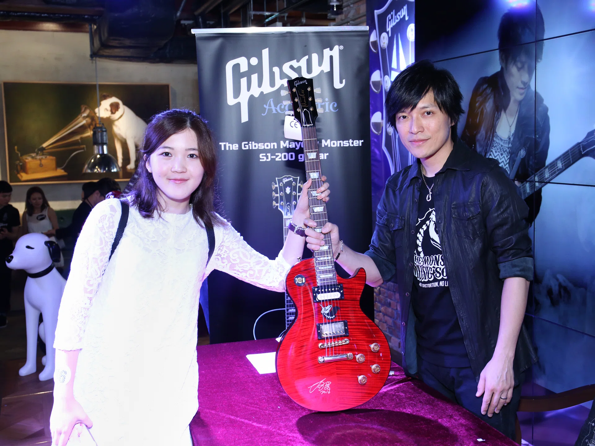 FAN: Monster with superfan Cynthia Zhu, who flew from New York City to Hong Kong to have her Epiphone Mayday Monster Les Paul electric guitar signed by the guitarist himself. 