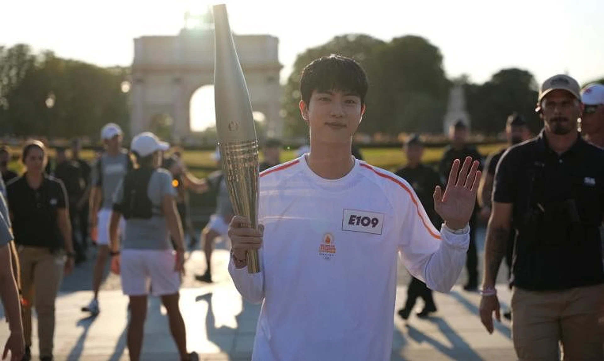 BTS singer Jin carrying the Paris Olympics torch in Paris on July 14.