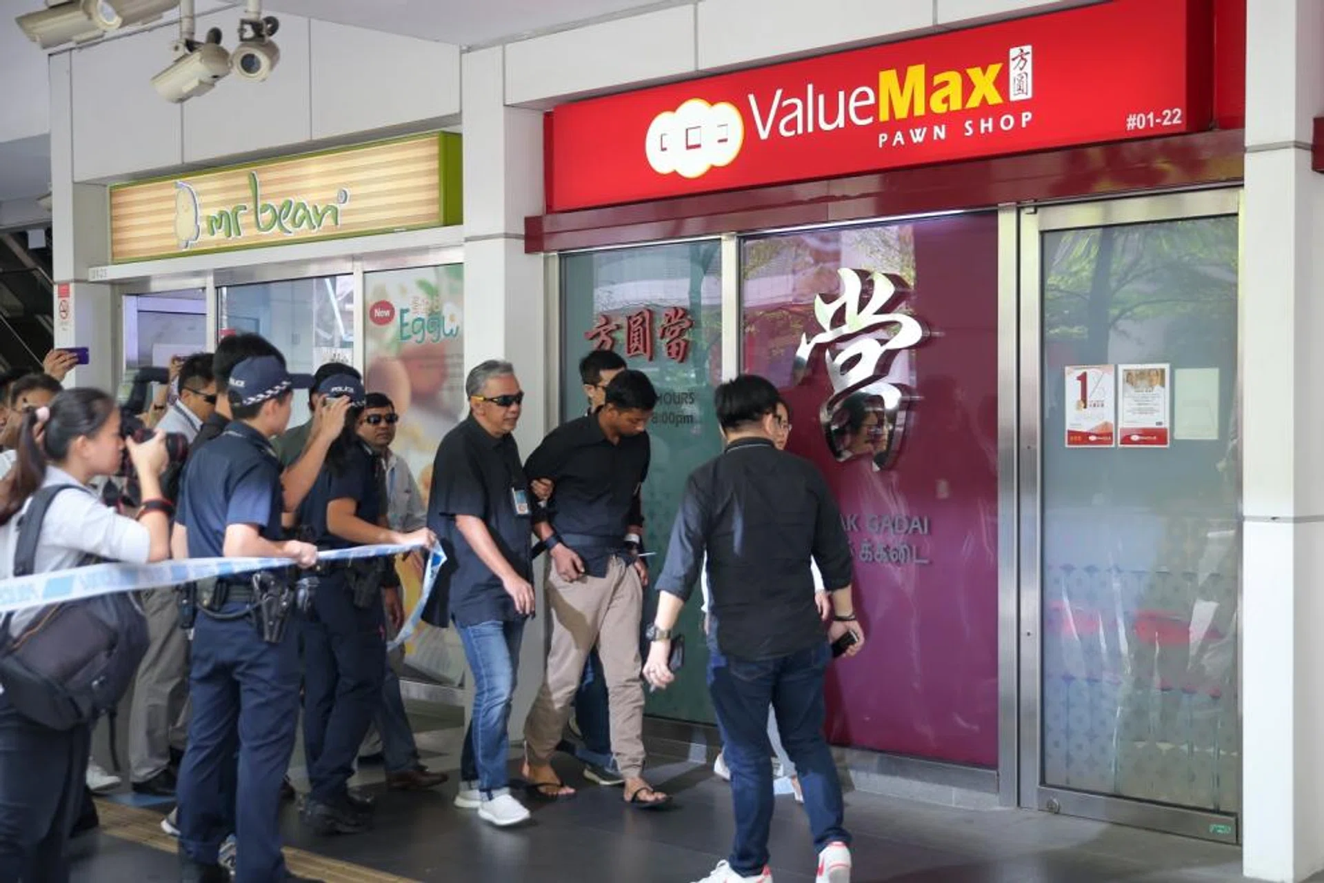 The suspect being taken back to the crime scene yesterday.