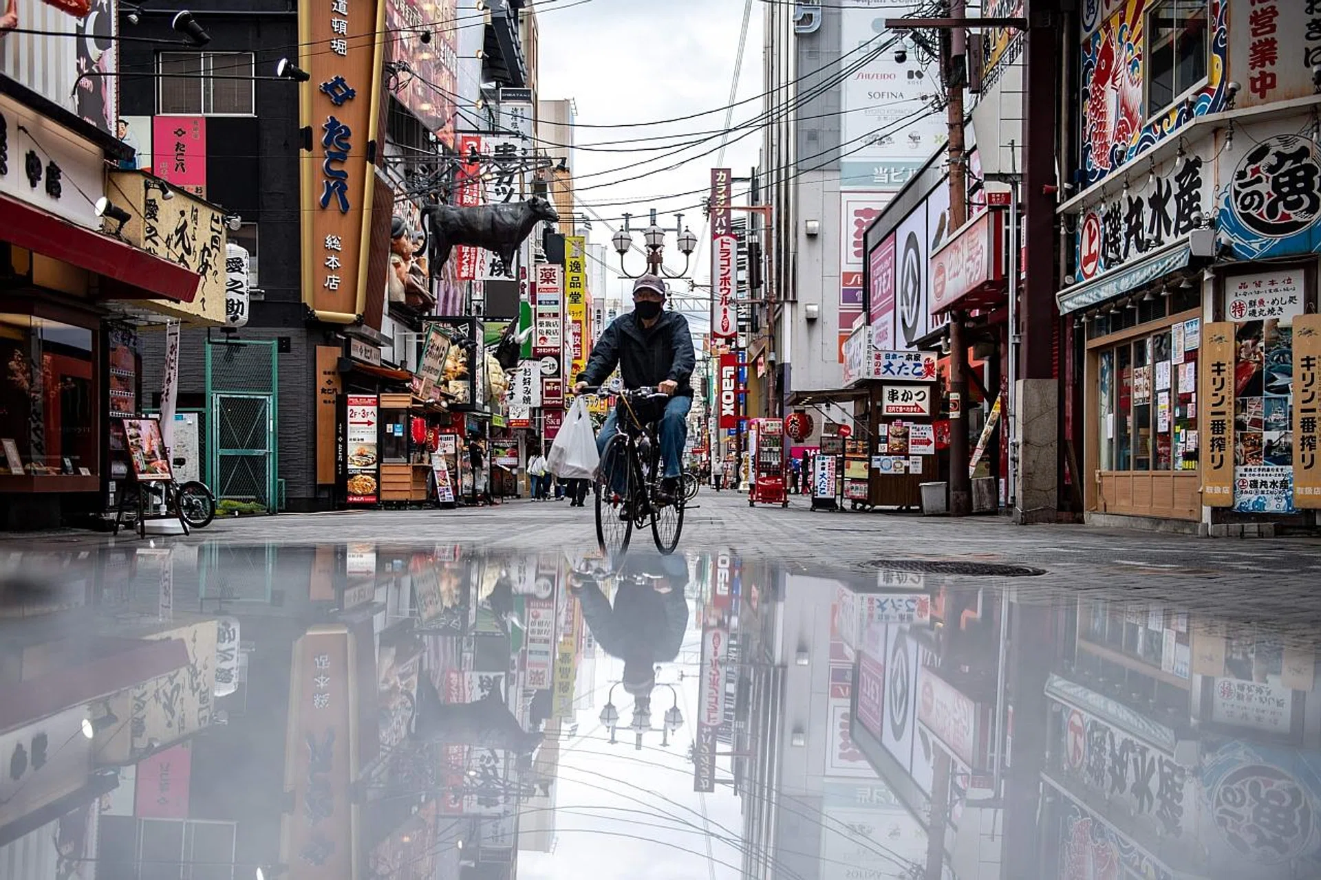 A man ridingin the Dotonbori area of Osaka, where over 96 per cent of the prefecture's critical care beds are occupied amid the pandemic.