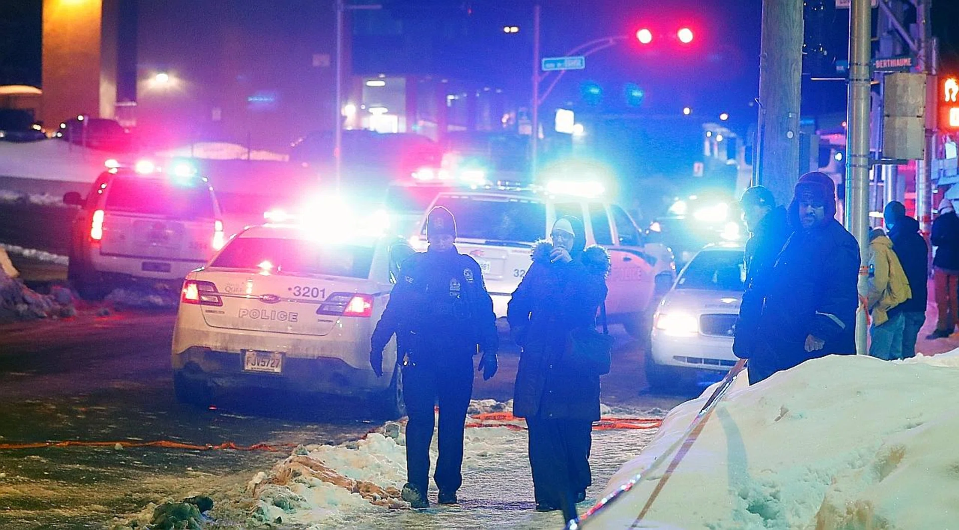 Police officers near a Quebec City mosque after a shooting on Sunday night. Two suspects have been arrested. 