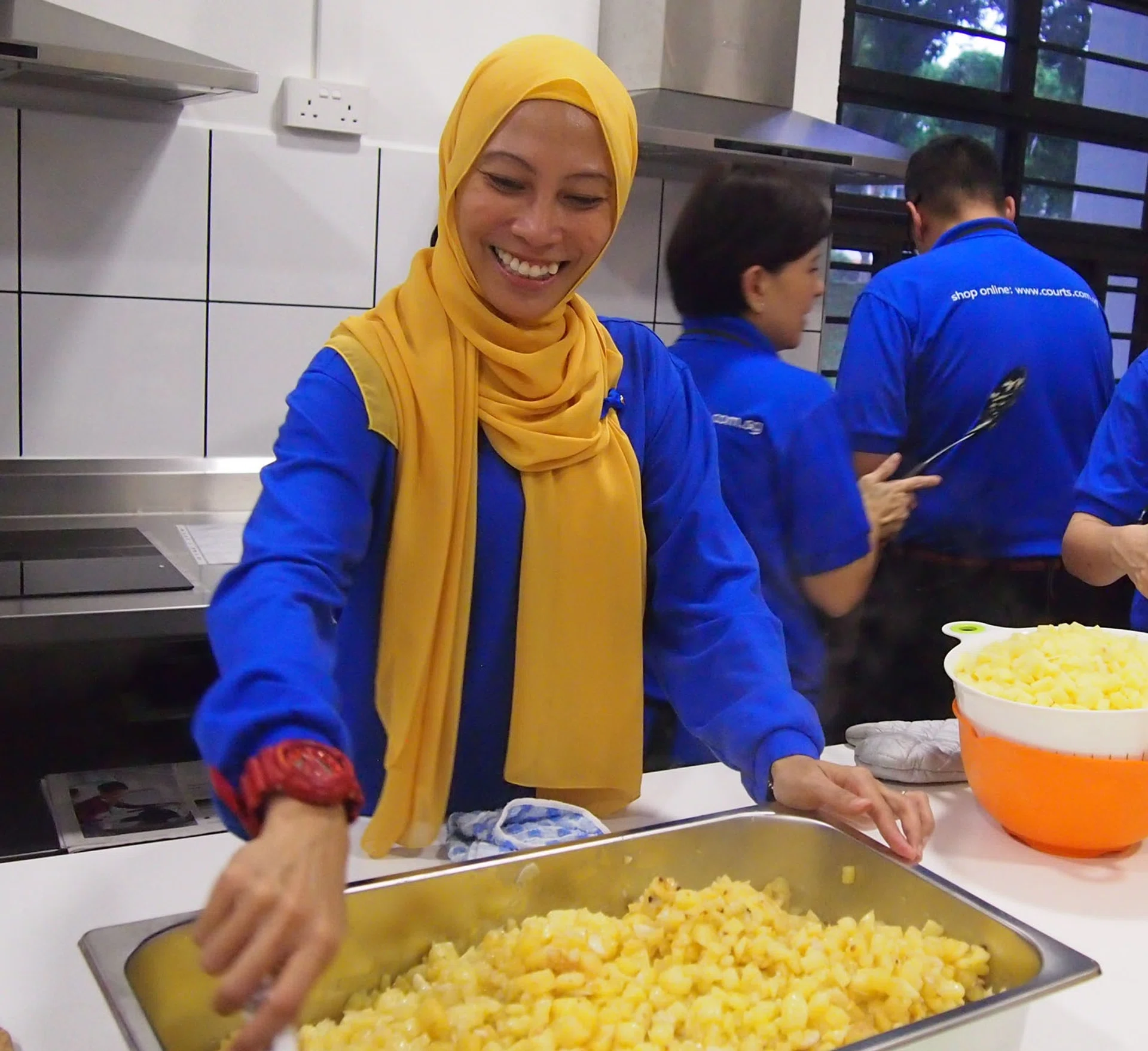 HAPPY: Ms Juzailah Abdul Rahin cooking for the needy.
