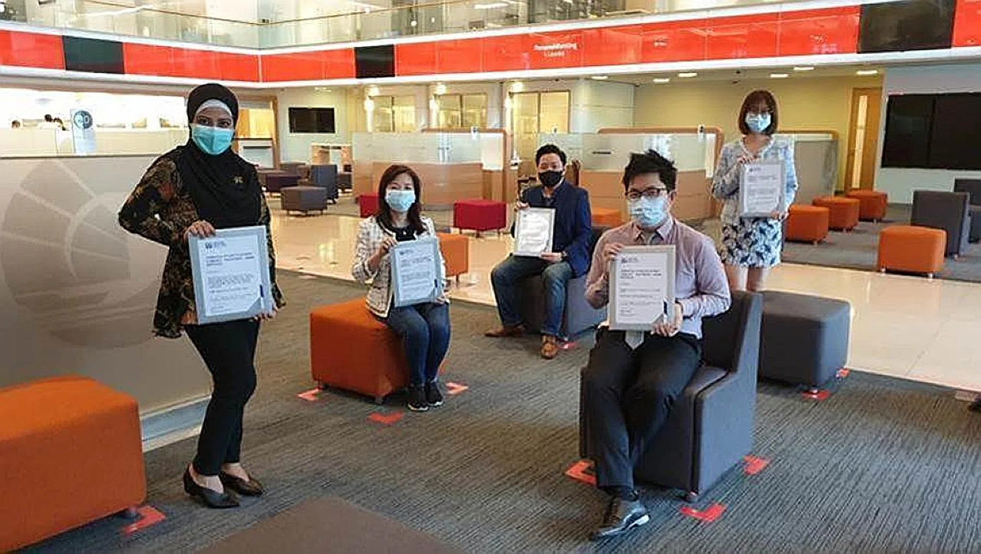 (From left) Ms Hilsham Helina Mohd Sahilman, Ms Yvonne Cheong, Mr Royston Soon, Mr Tok Wee Liang and Ms Eng Ai Lin, all representing OCBC Bank, received the Community Partnership Award from the Singapore Police Force last Friday.  