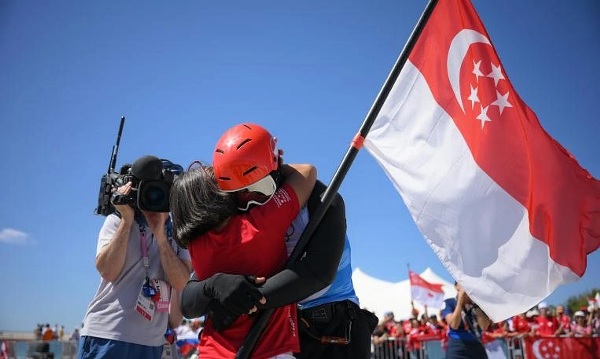 Singaporean Kitefoiler Maximilian Maeder hugs his mother after race 3of the Paris 2024 Olympics Men’s Kite final at the Marseille Marina on August 9, 2024.