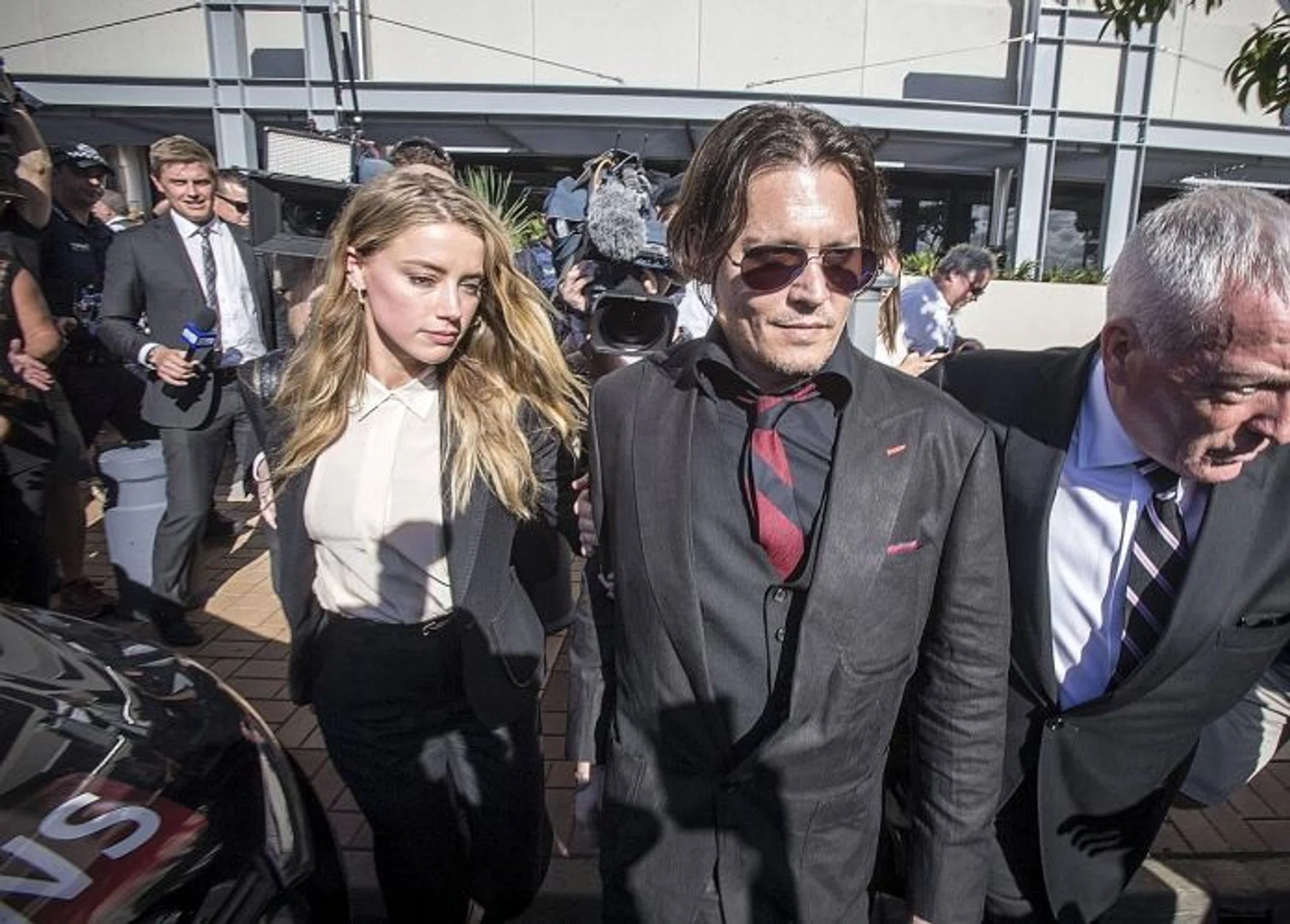 SMUGGLE: (From left) The "war on terrier" started when US actress Amber Heard was discovered to have brought two dogs to Australia without declaring them. She was visiting husband, US actor Johnny Depp, who was filming the latest Pirates Of The Caribbean movie.
