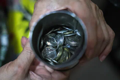 A tin filled with coins belonging to Megan Khung.