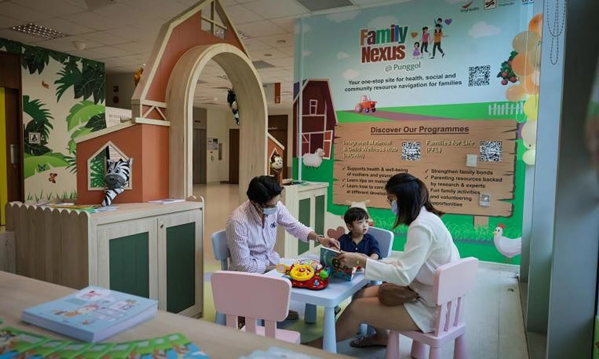 Mr Amparo Juan Carlos Camero (left), his wife Jasmine Tan and their son at the Family Nexus@Punggol located at Punggol Polyclinics, on Jan 22